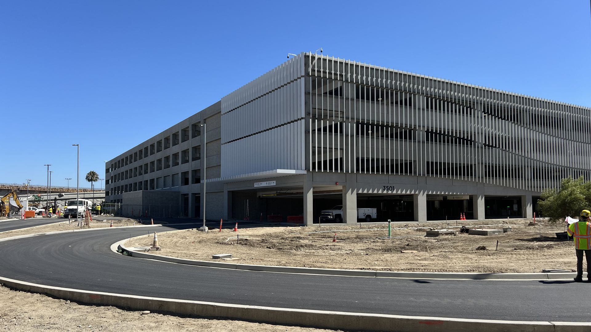The front of a parking structure under construction at an airport.