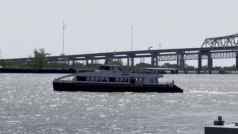Image shows the Algiers Ferry crossing the Mississippi River.