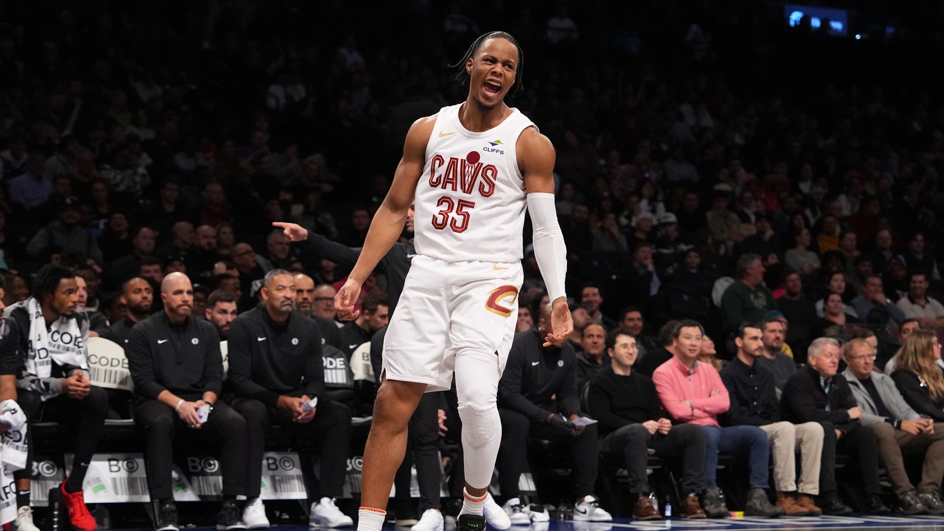 Cavs Isaac Okoro in white uniform celebrating on court
