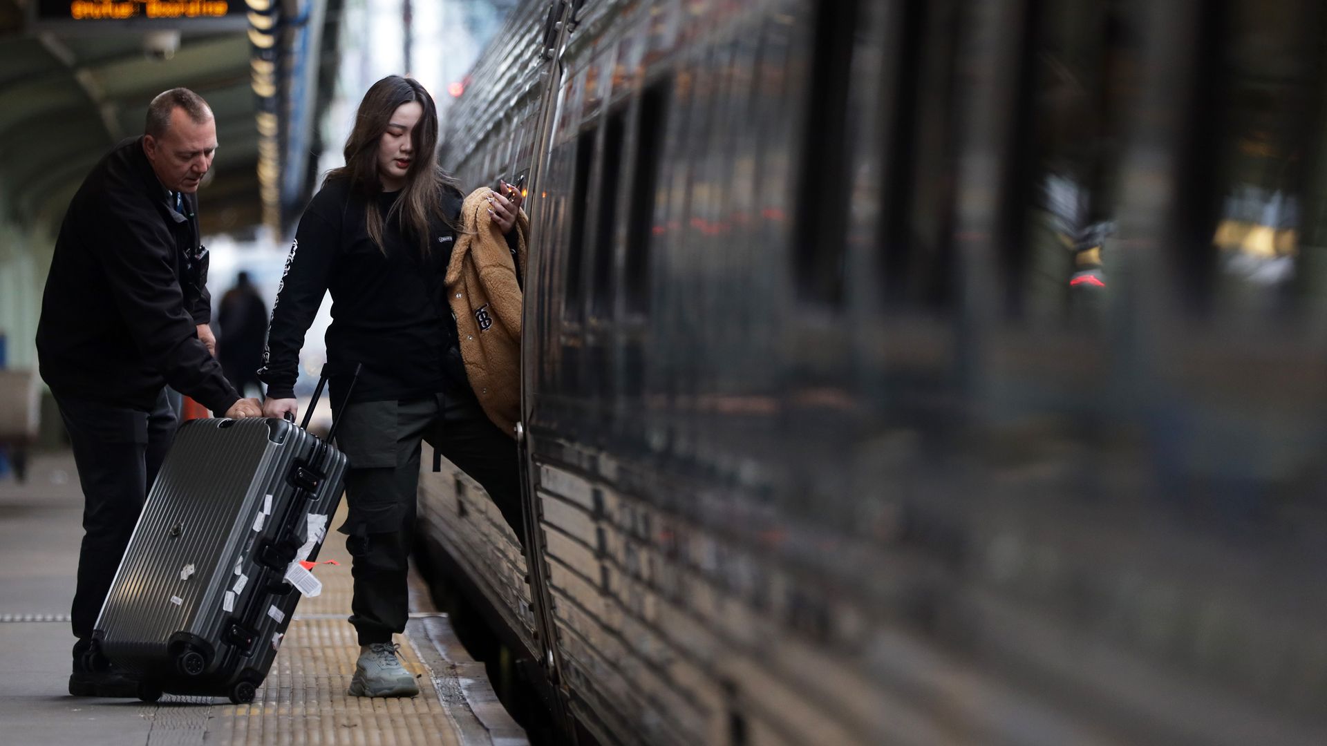 A passenger boarding an Amtrak train