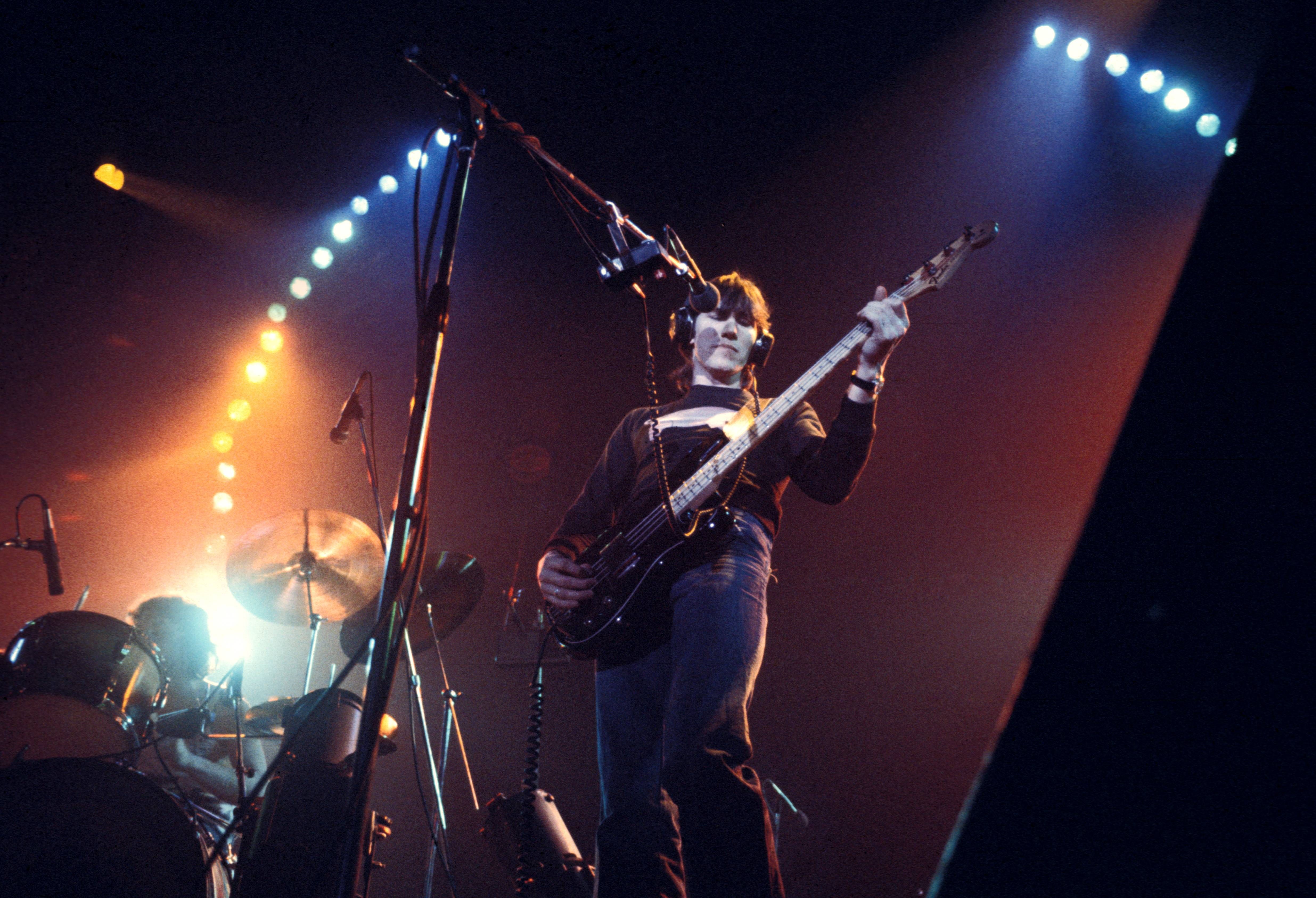 Pink Floyd's Roger Waters plays bass on stage in the 1970s. 