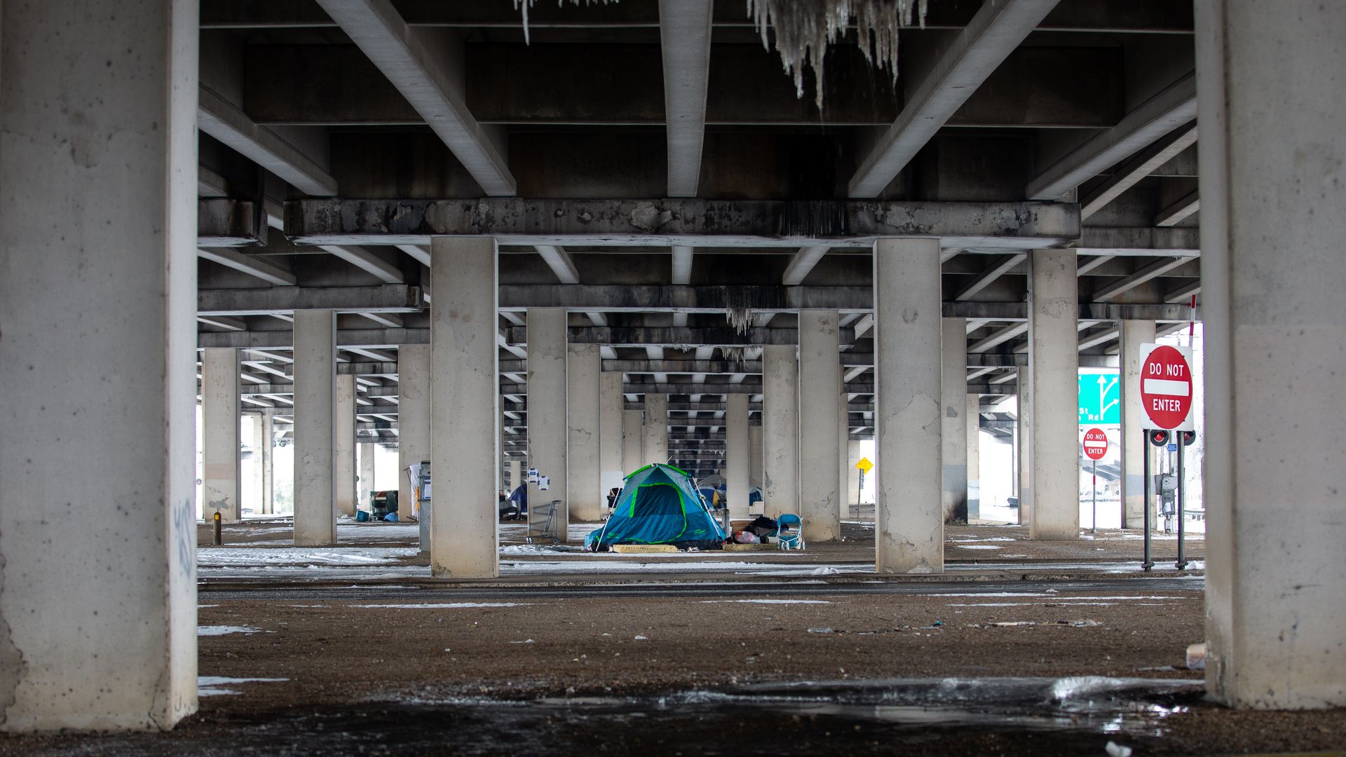 A homeless encampment under a bridge