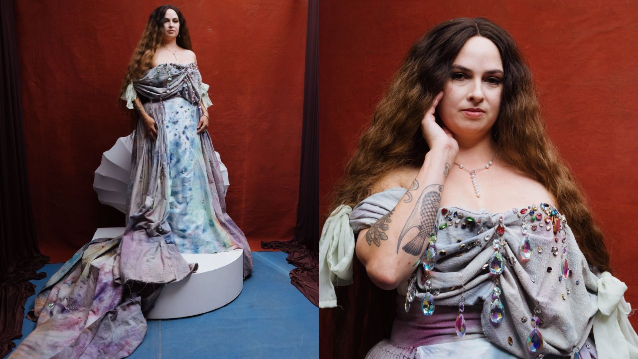 Two-panel portrait of a woman in an off-shoulder gray gown with crystal adornments and a long train. Left: full-length on a blue floor; right: close-up of her face, necklace, crystals, and arm tattoos against a red backdrop.