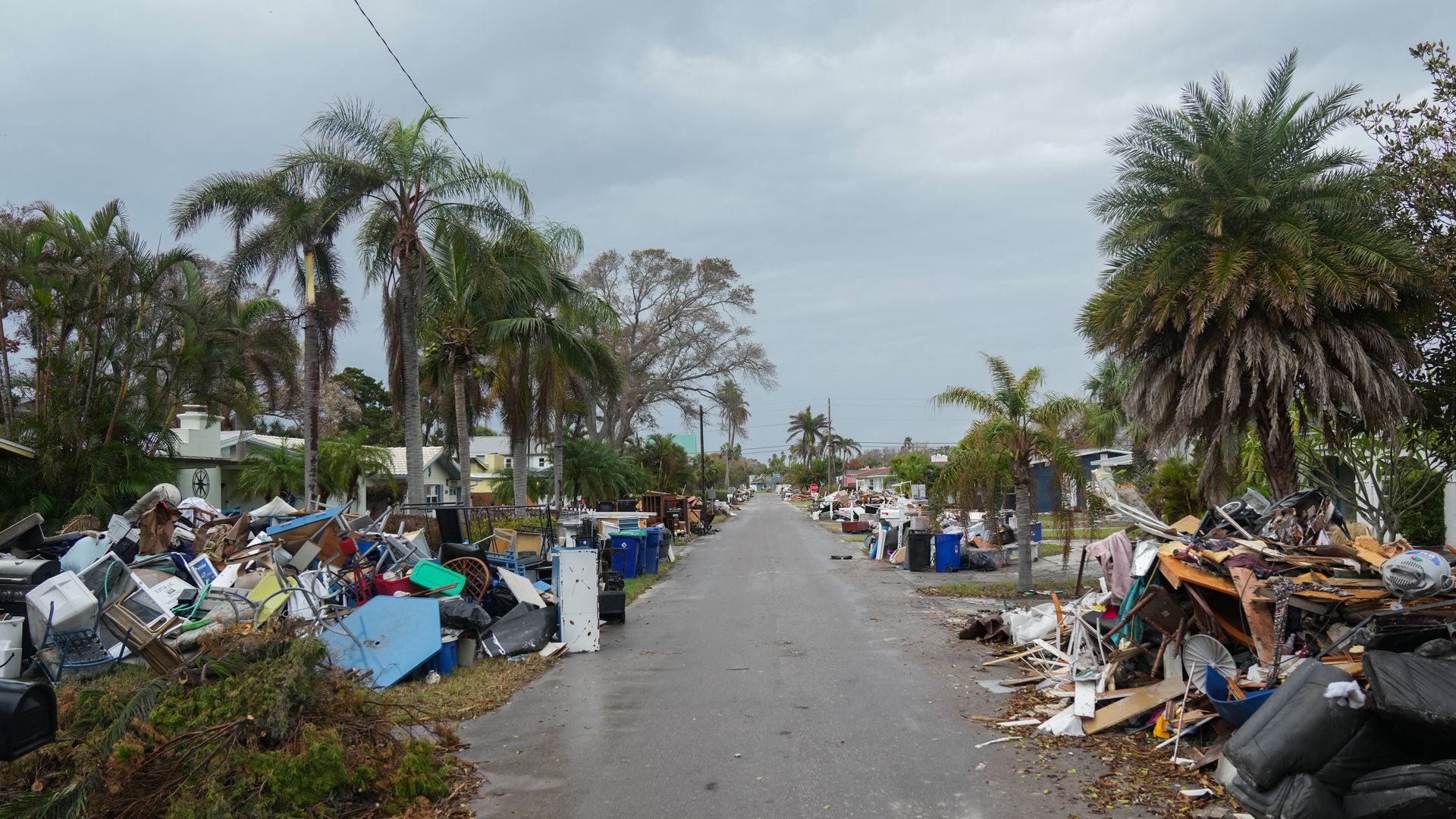 Debris from Hurricane Helene lines a street in the Redington Beach after Hurricane Milton.