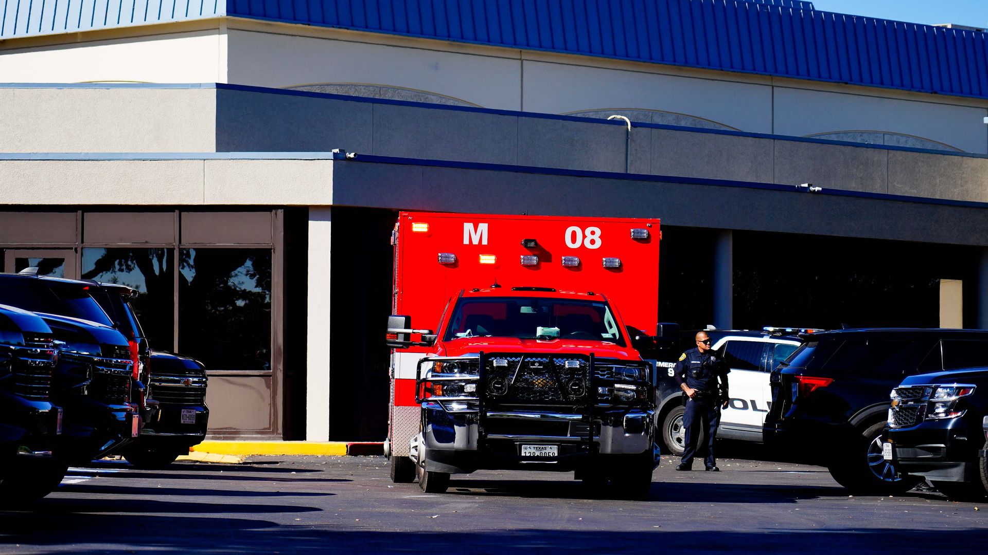 A red ambulance in a parking lot