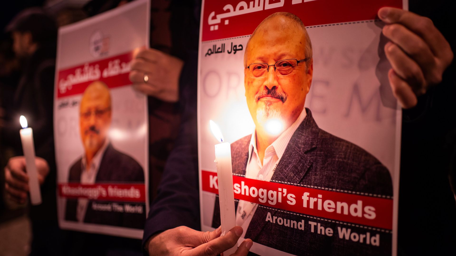 Jamal Khashoggi on a poster next to a candle.