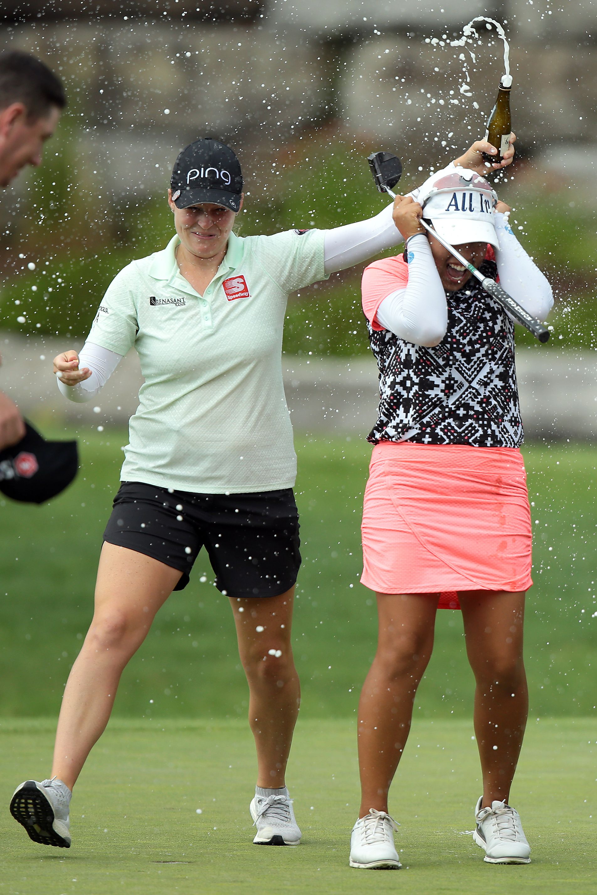 Ally McDonald (left) pours a drink on Jasmine Suwannapura of Thailand after winning the Dow Great Lakes Bay Invitational at Midland Country Clubin Midland, Michigan, on Saturday.