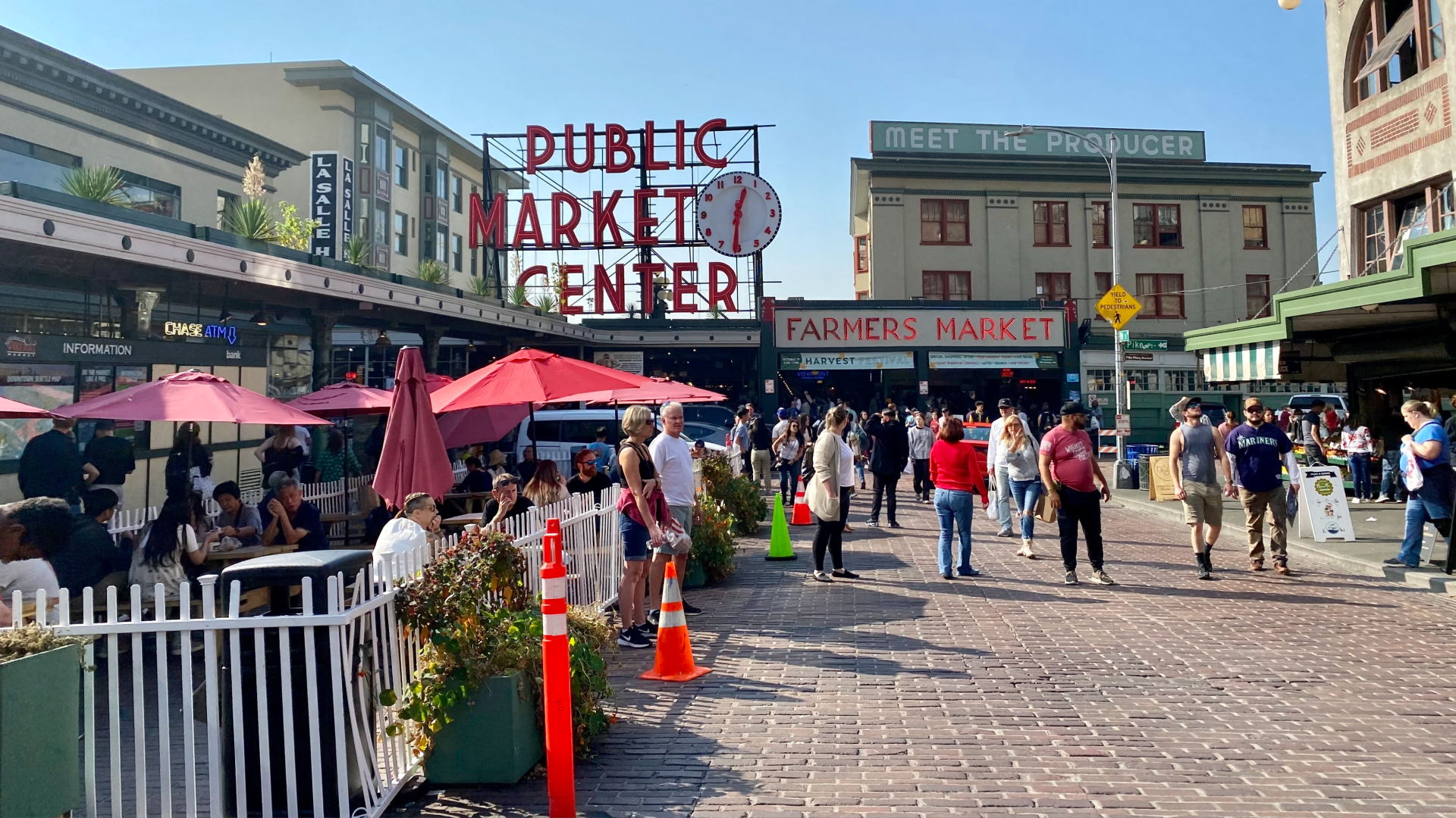 People mill around and browse outside Pike Place Market in Seattle. 