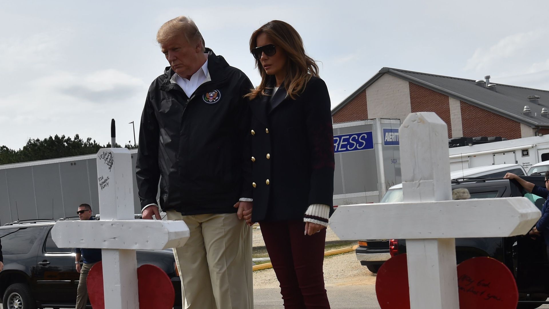 President Trump and Melania Trump view crosses honoring 23 people killed in an Alabama storm.