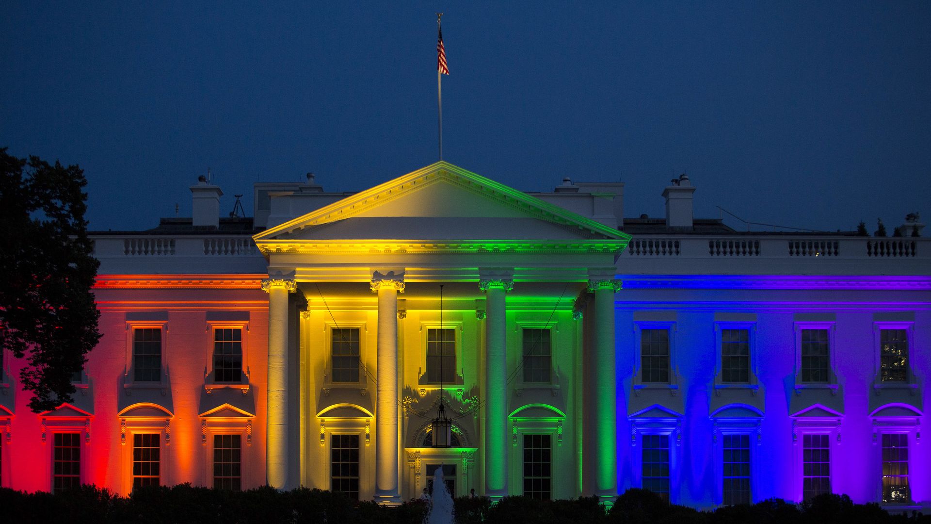 The White House is illuminated in rainbow lights.