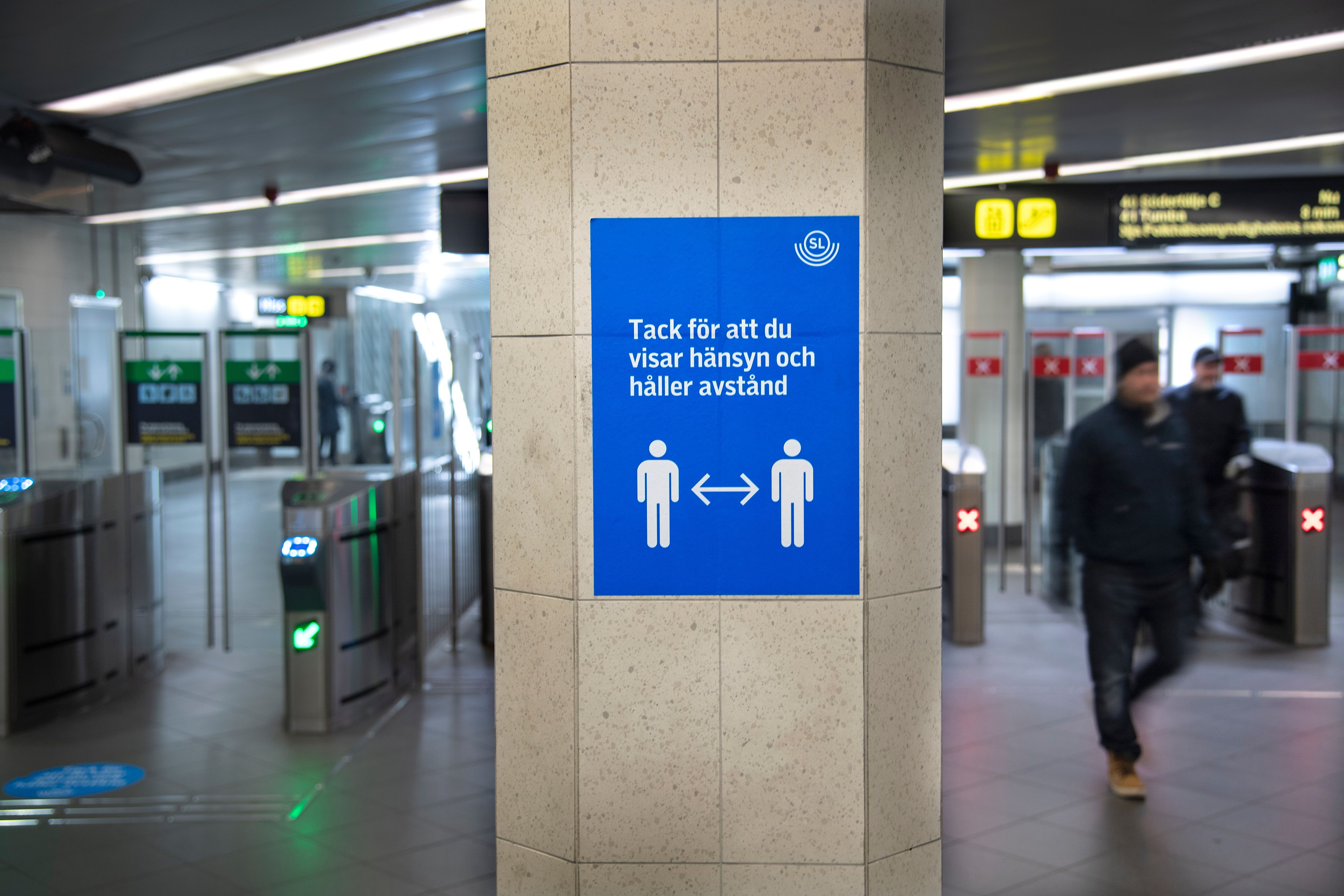 Travelers are seen on November 4, 2020 at a station of the public transport in Stockholm, where people are requested to maintain social distancing