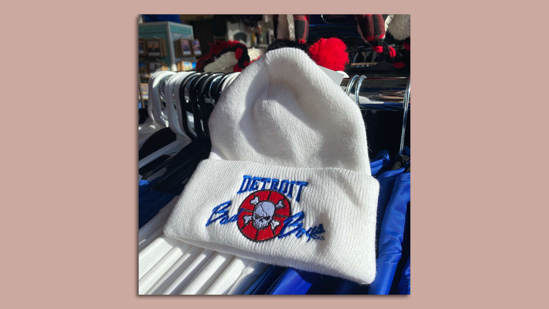 A hat that is white and says "Detroit Bad Boys with a small skull