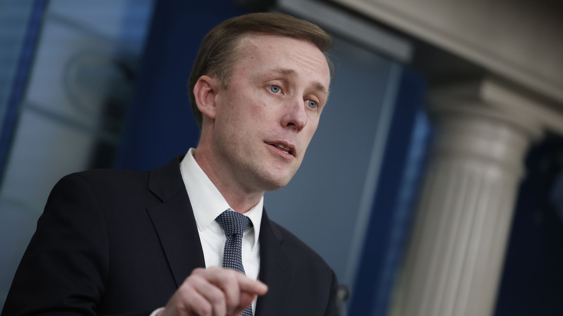 Jake Sullivan speaks to reporters, pointing a finger.