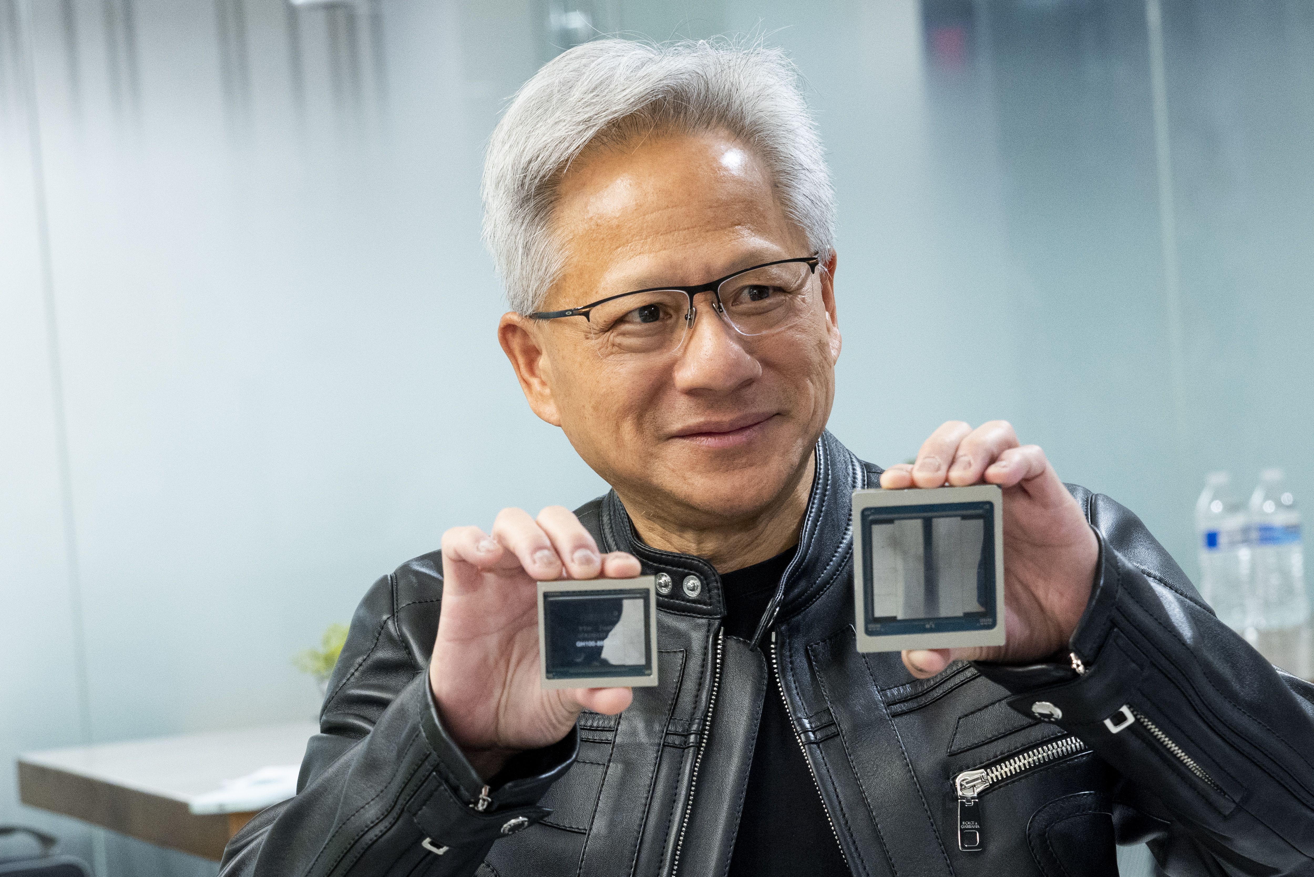 Nvidia CEO Jensen Huang shows off two generations of his company's chips in Washington on Friday.