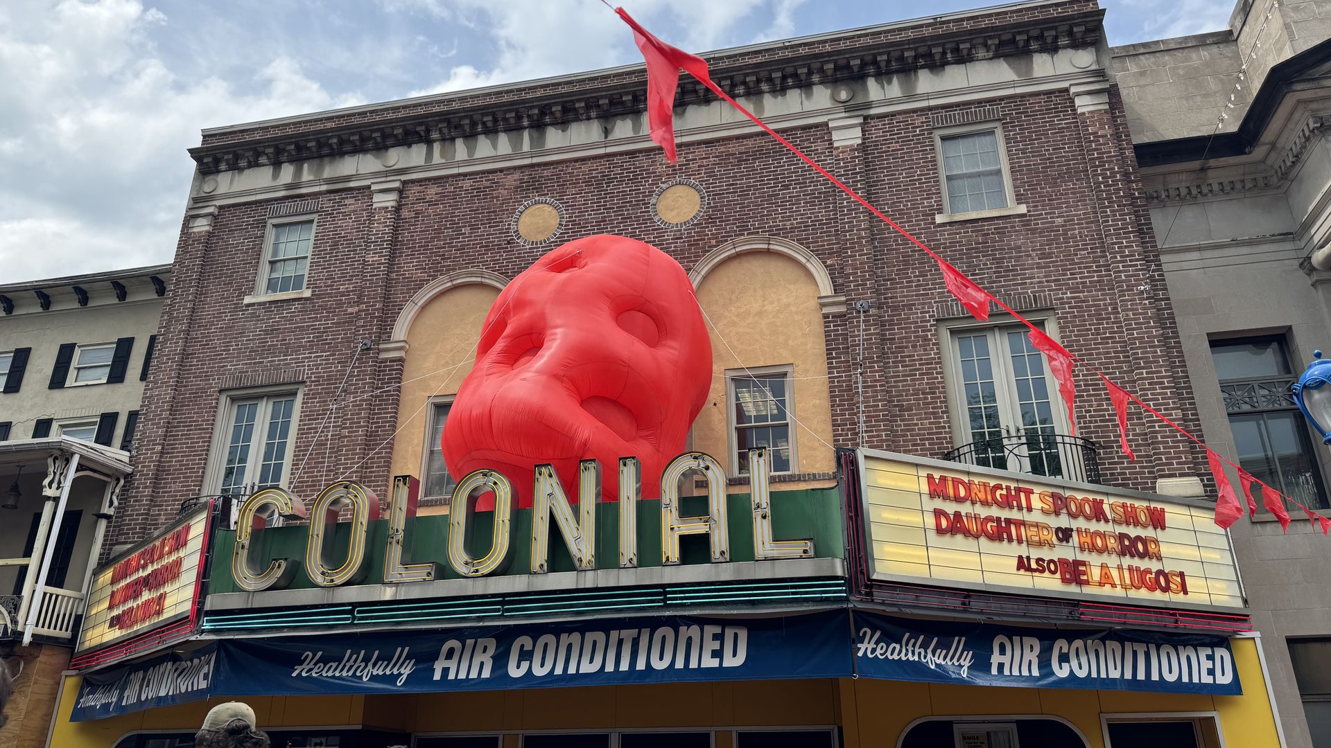 The front of the Colonial Theater with marquees and a giant inflatable blob on top