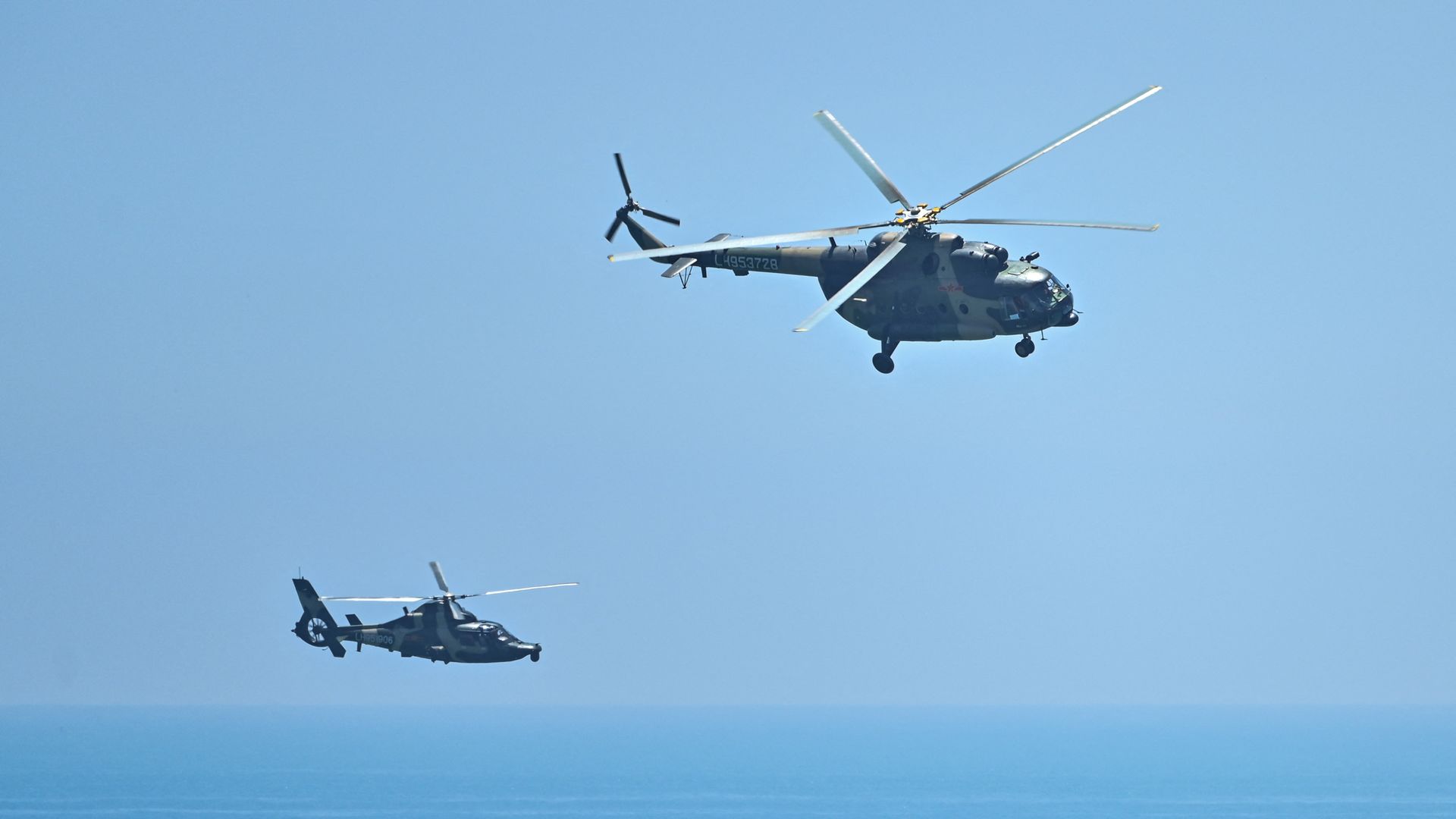 Chinese military helicopters fly past Pingtan island, one of mainland China's closest point from Taiwan, in Fujian province on August 4, 2022