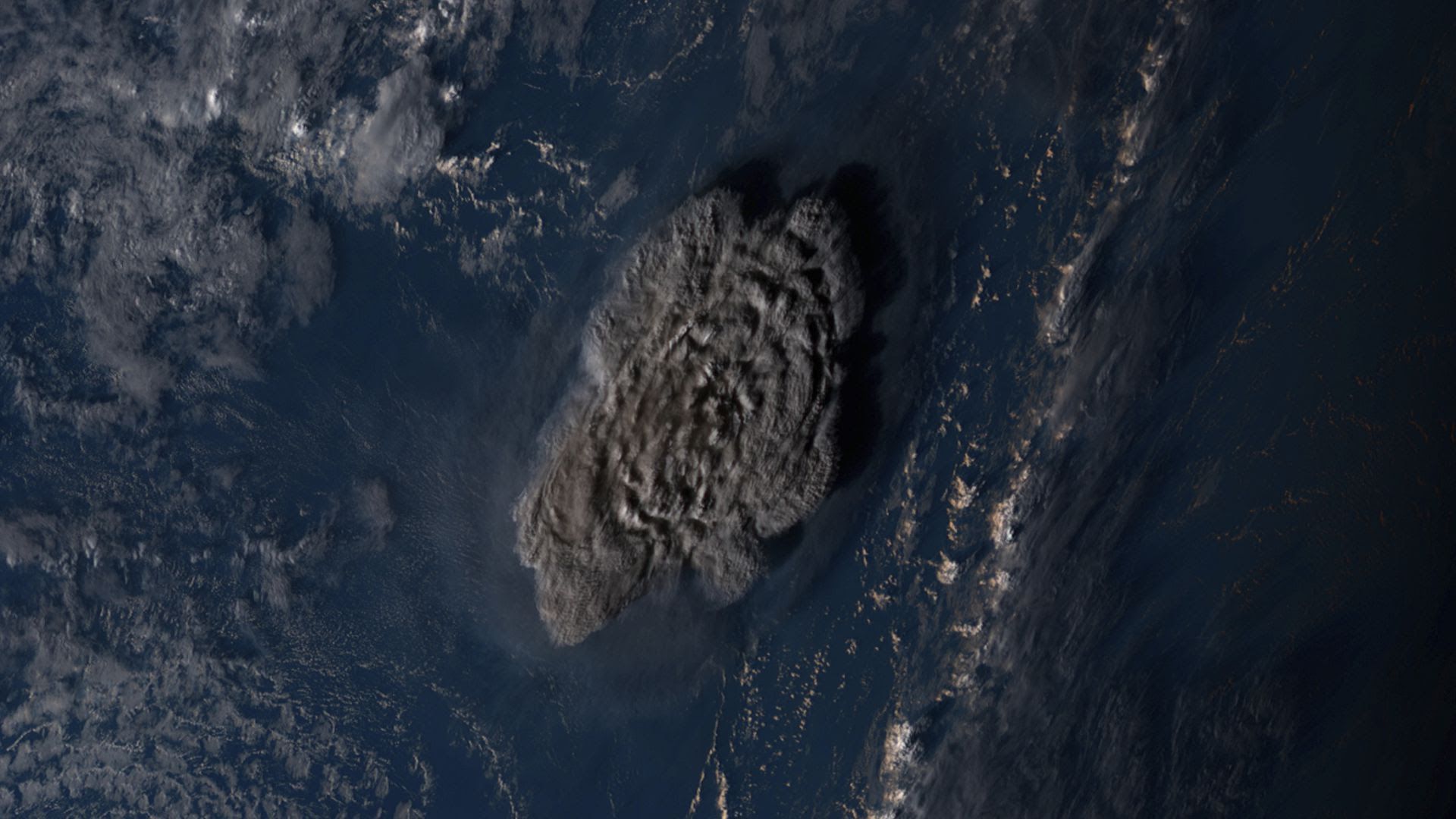 Himawari-8 satellite image, released by the National Institute of Information and Communications Technology shows the Tonga undersea volcano eruption Saturday, Jan. 15, 2022. (NICT via AP)