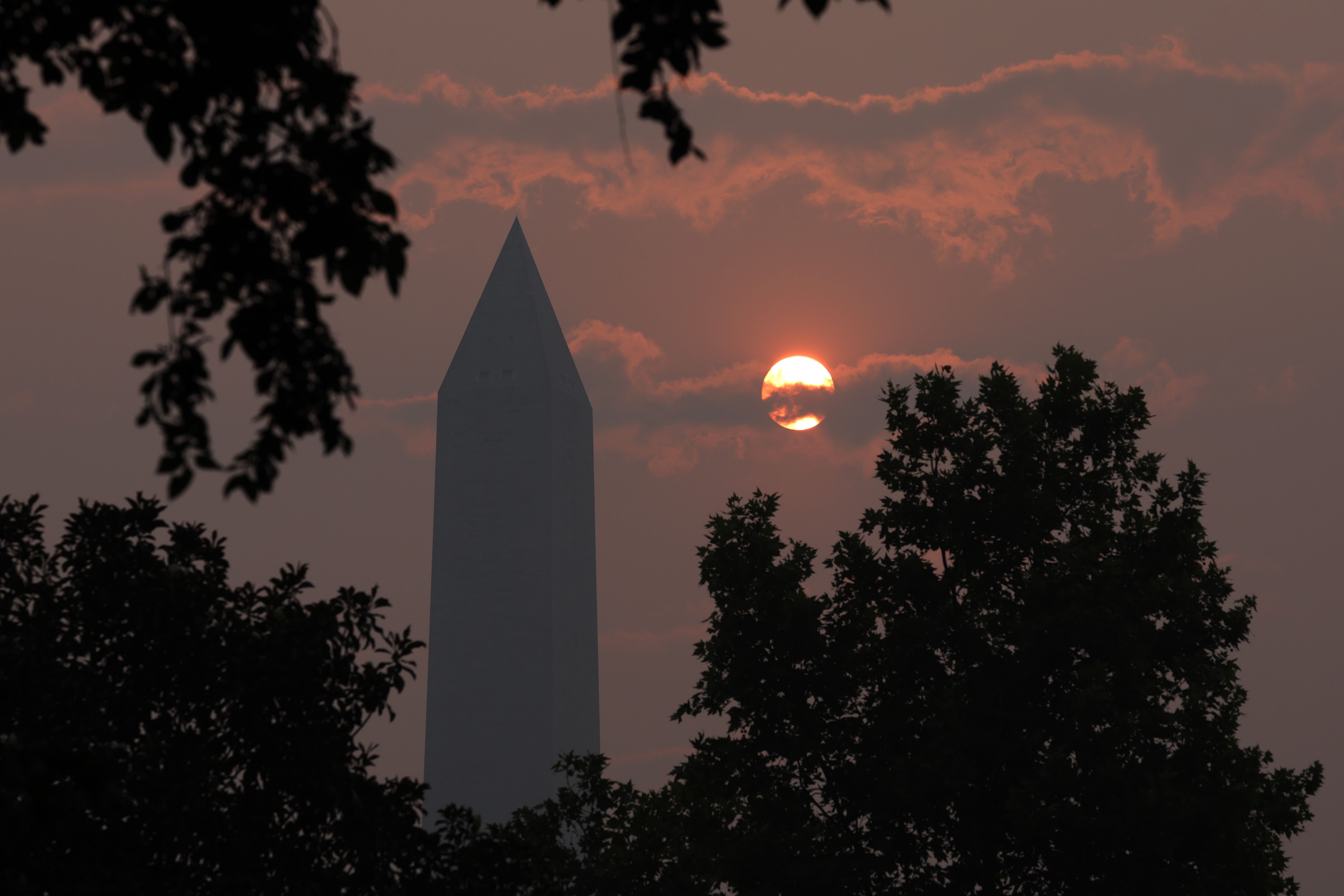 Washington Monument at sunrise in a haze of smoke from wildfires. 