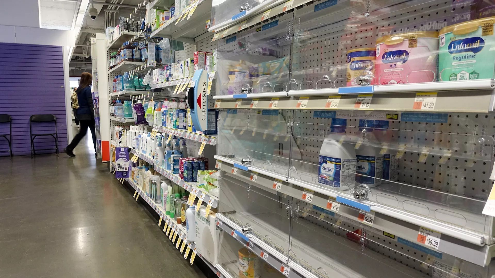 A nearly empty baby formula display shelf is seen at a Walgreens pharmacy