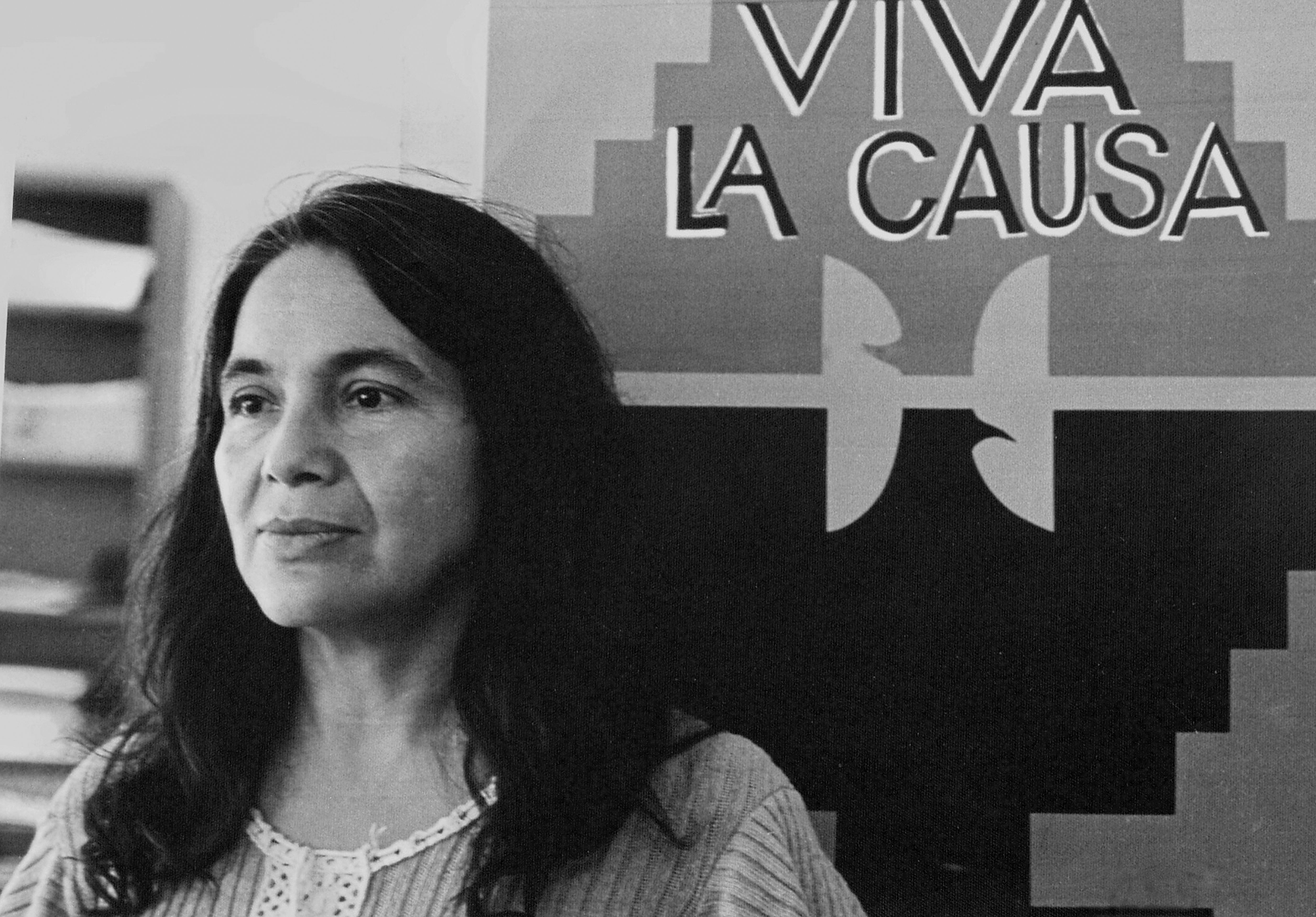 Dolores Huerta, co-founder of the United Farm Workers group, with a union flag that reads 'Viva La Causa', 1970s.