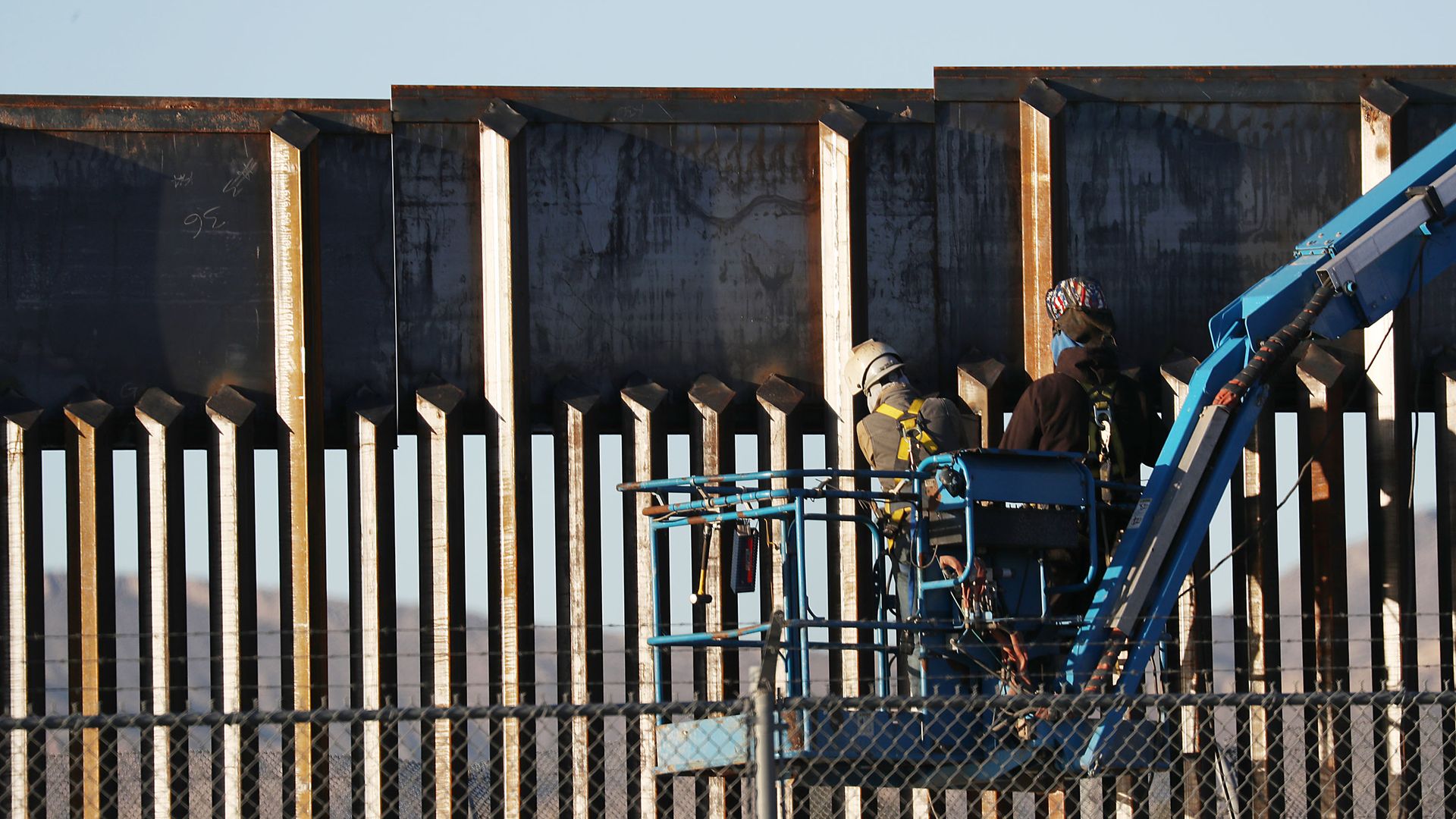 People work on the U.S.-Mexico border wall in Texas