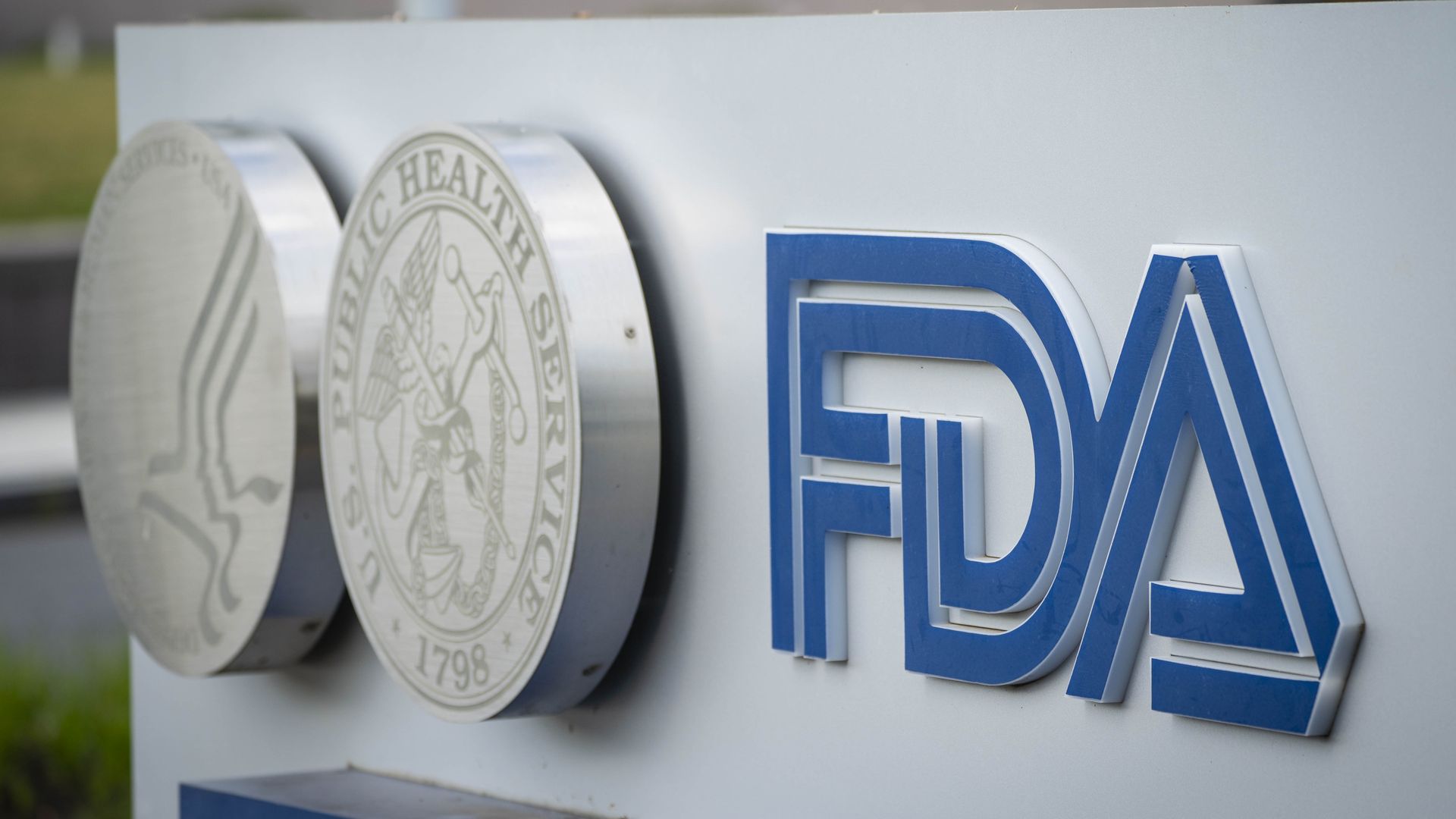 The blue FDA logo and sign outside of its headquarters building.