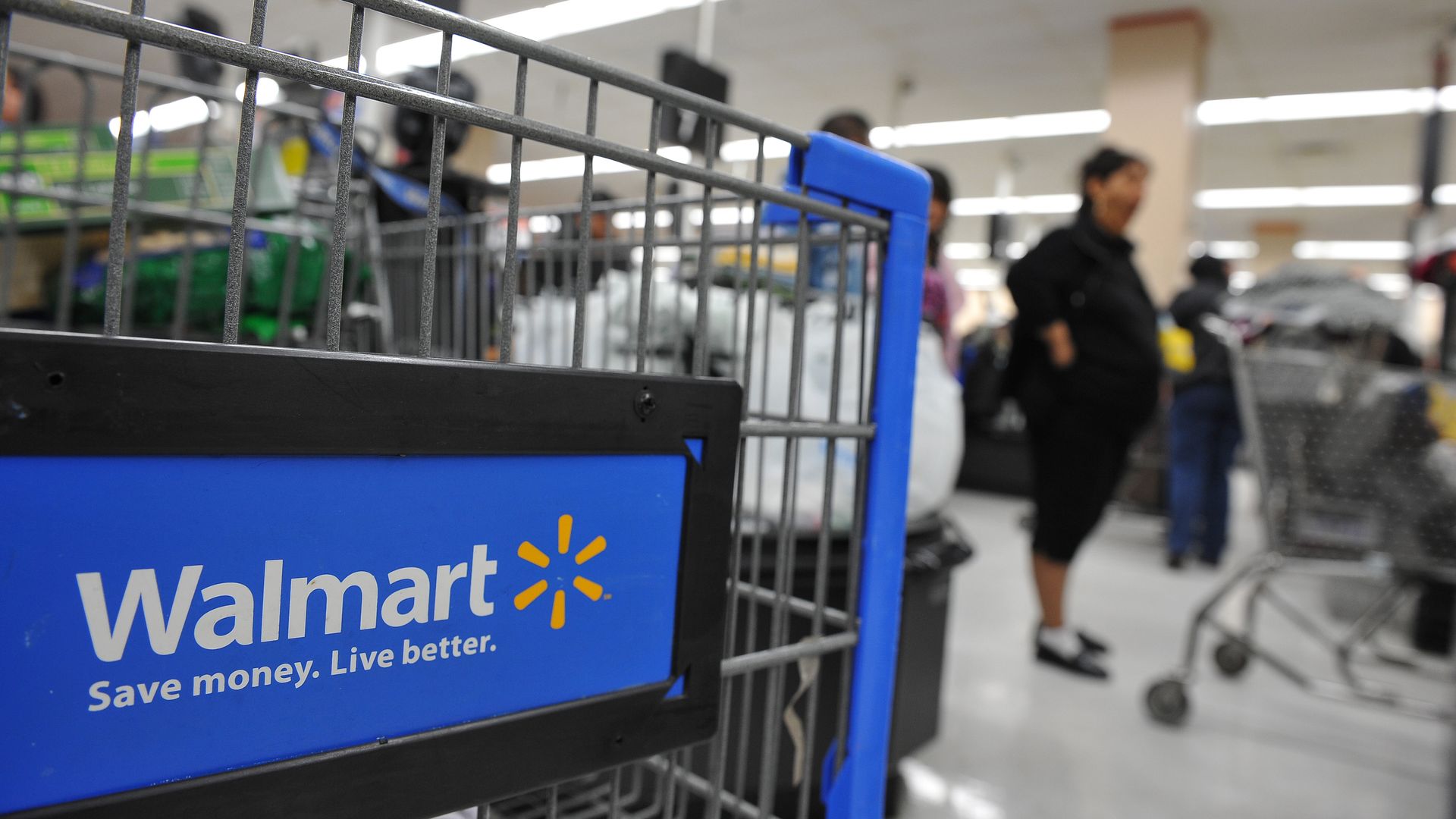 Walmart's logo on a shopping cart.