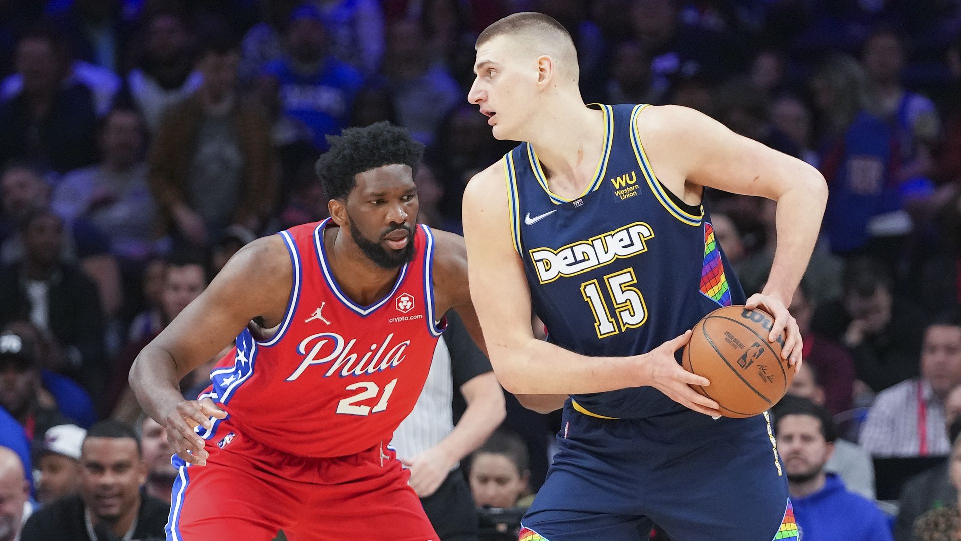 Nikola Jokić faces off against Philadelphia 76ers center Joel Embiid.
