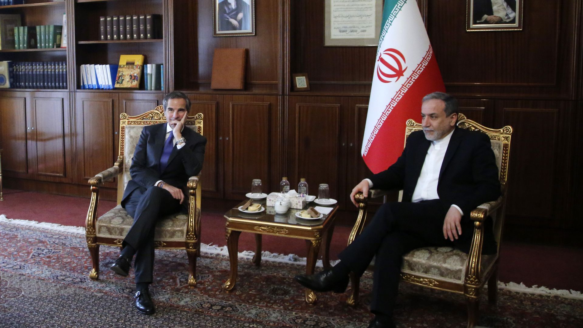 Aragchi and grossi in chair with iranian flag