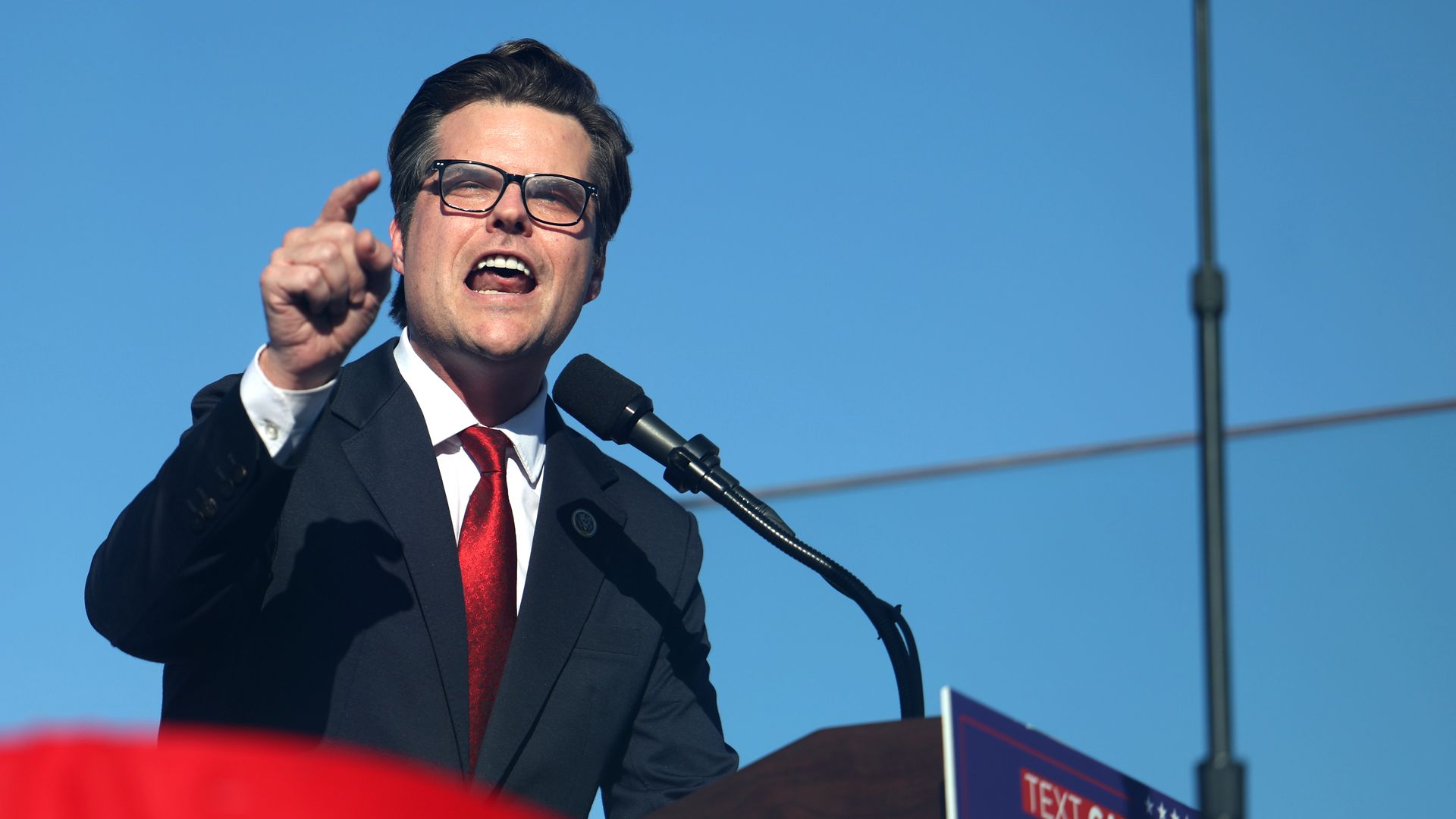 Matt Gaetz speaks outdoors into a microphone.