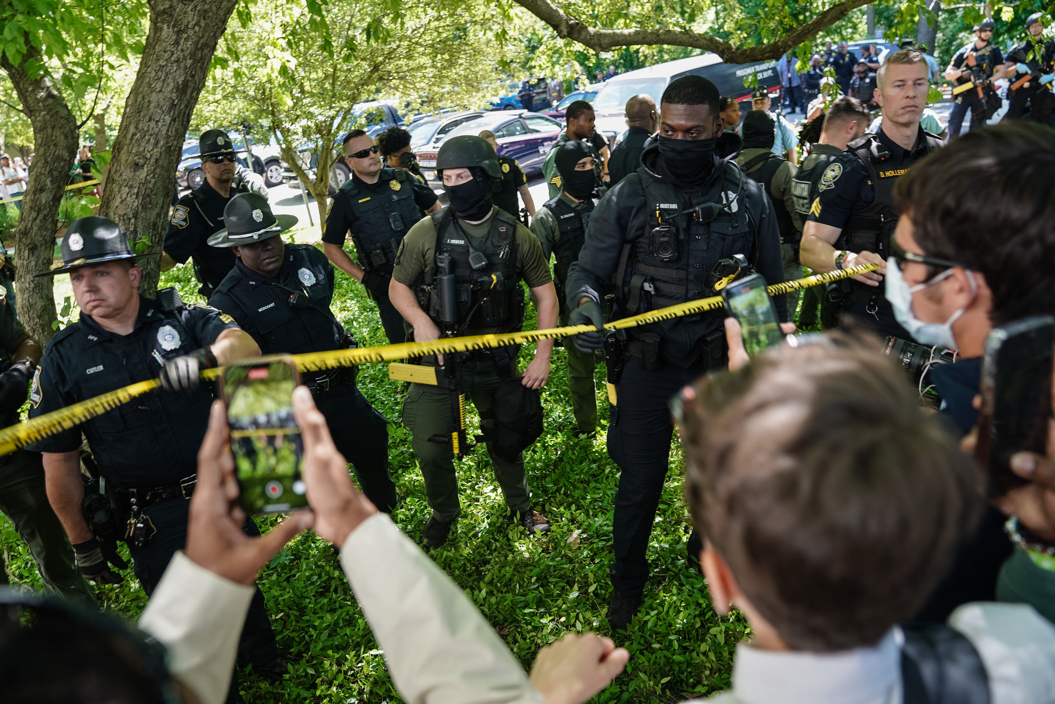 Police officers behind yellow tape at a campus protest in Atlanta. 