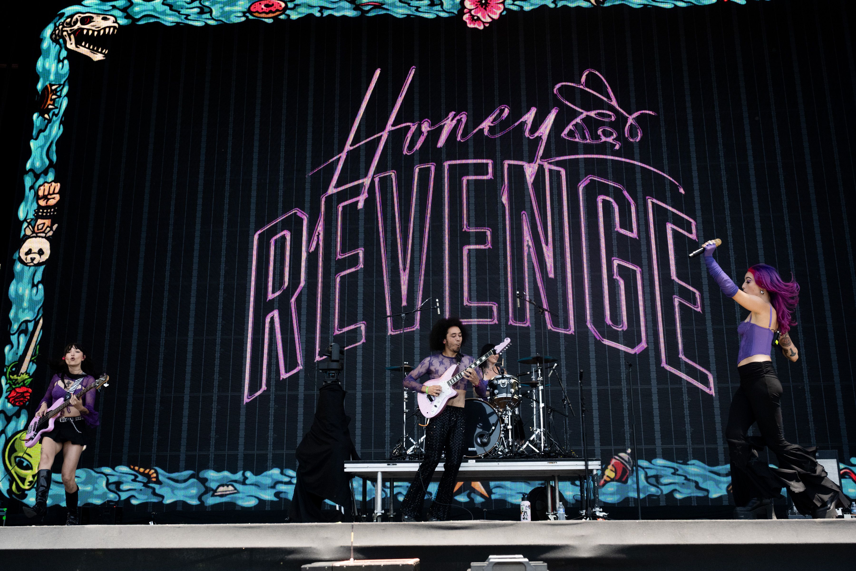 Singer Devin Papadol (C) of Honey Revenge performs onstage during day 2 of Warped Tour at Shoreline Waterfront on July 27, 2025 in Long Beach, California.