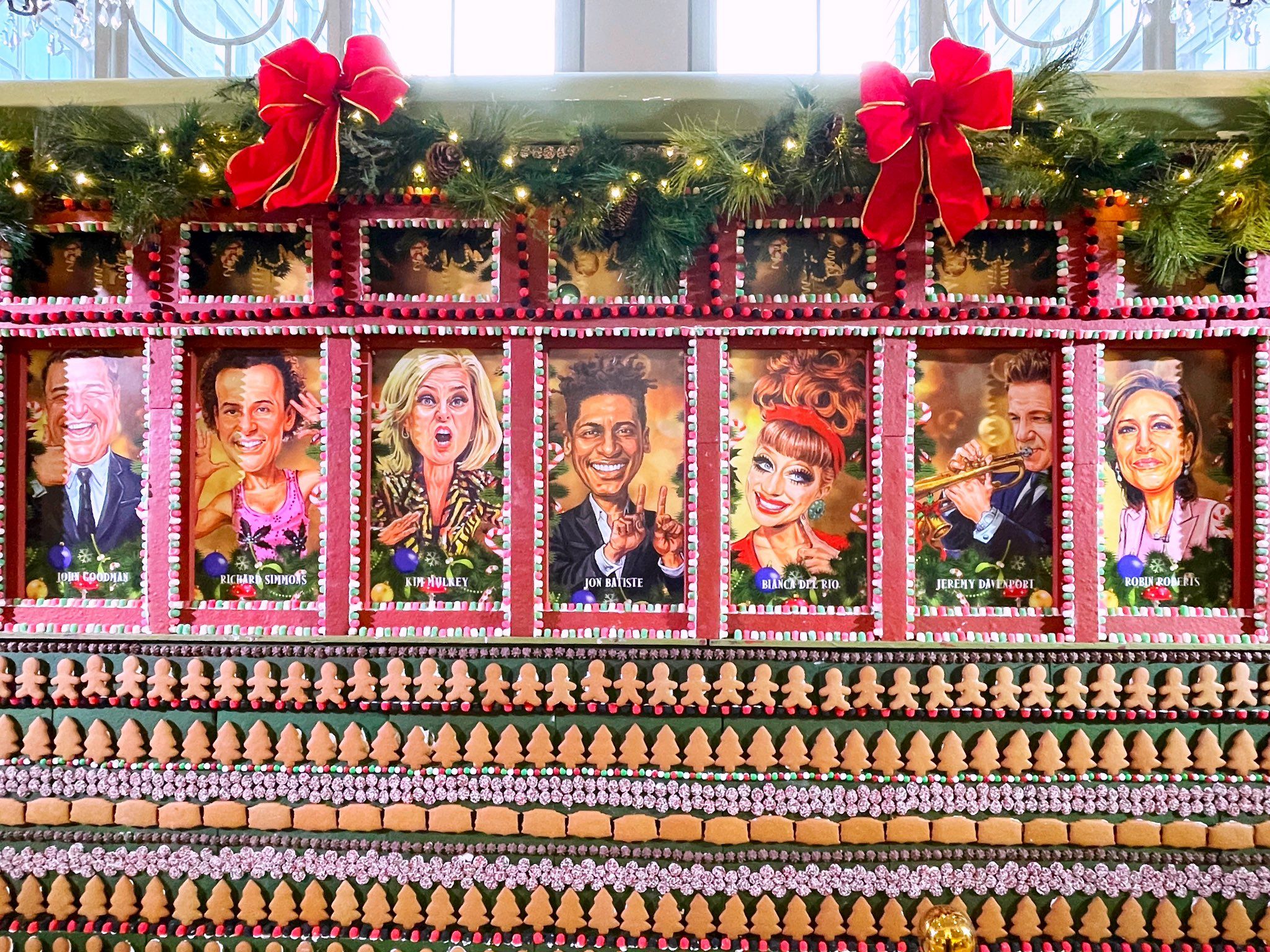 Photo shows portraits of famous people painted the side of a gingerbread streetcar