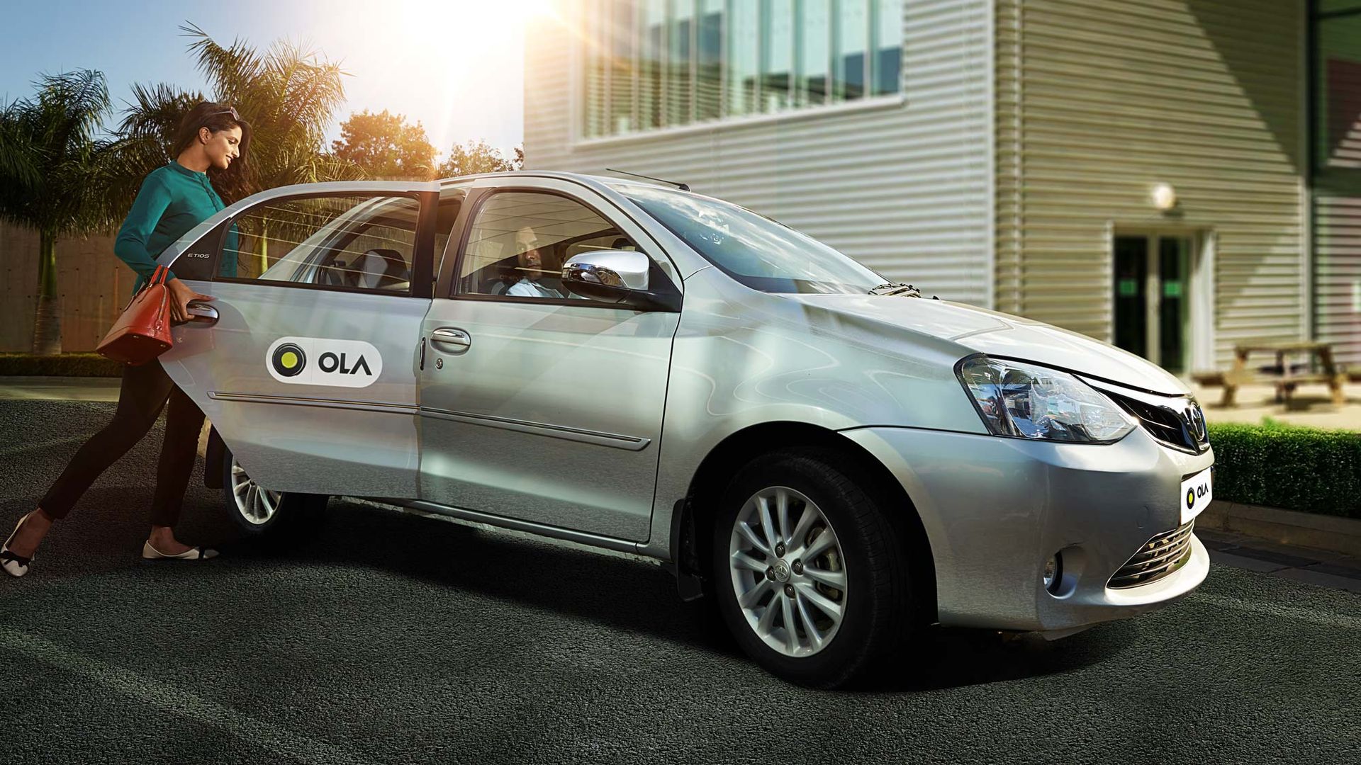 Woman getting into an Ola car. 
