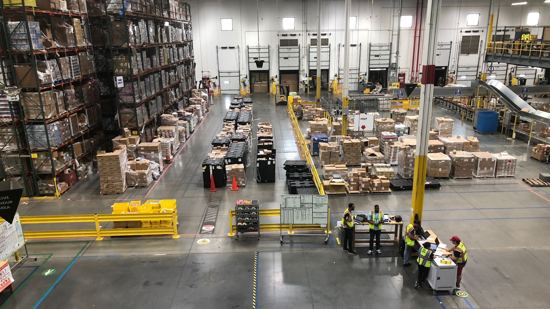 A bird's eye view of a warehouse with packages stacked high