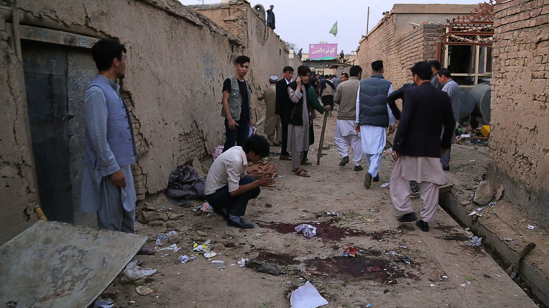 Residents gather at a site following a suicide bomber blew himself up in an education centre, in Kabul