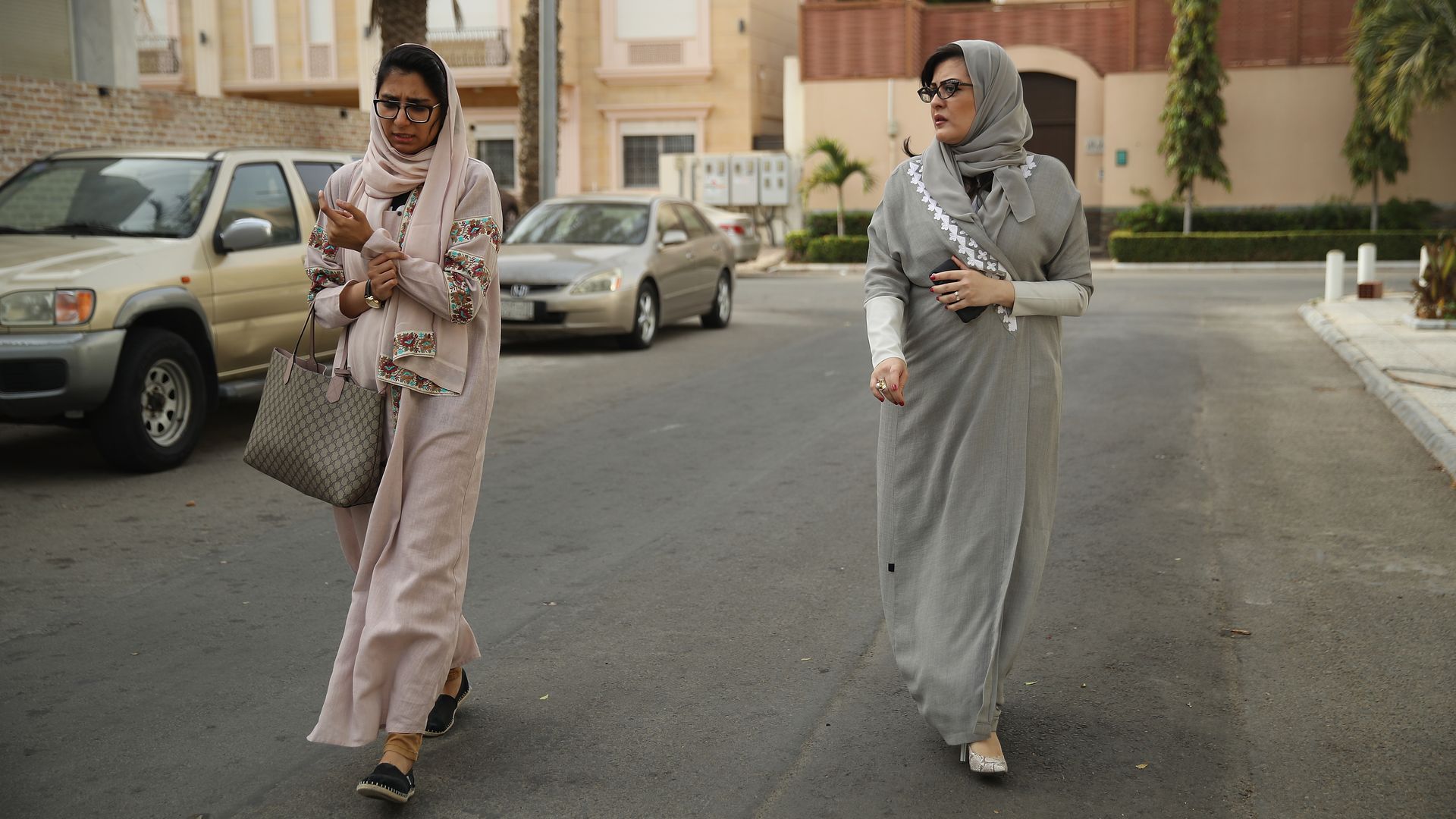 Two Saudi women walk on the street