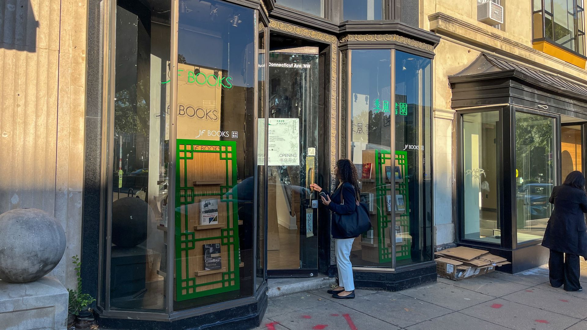 A woman walks into the new JF Books storefront.