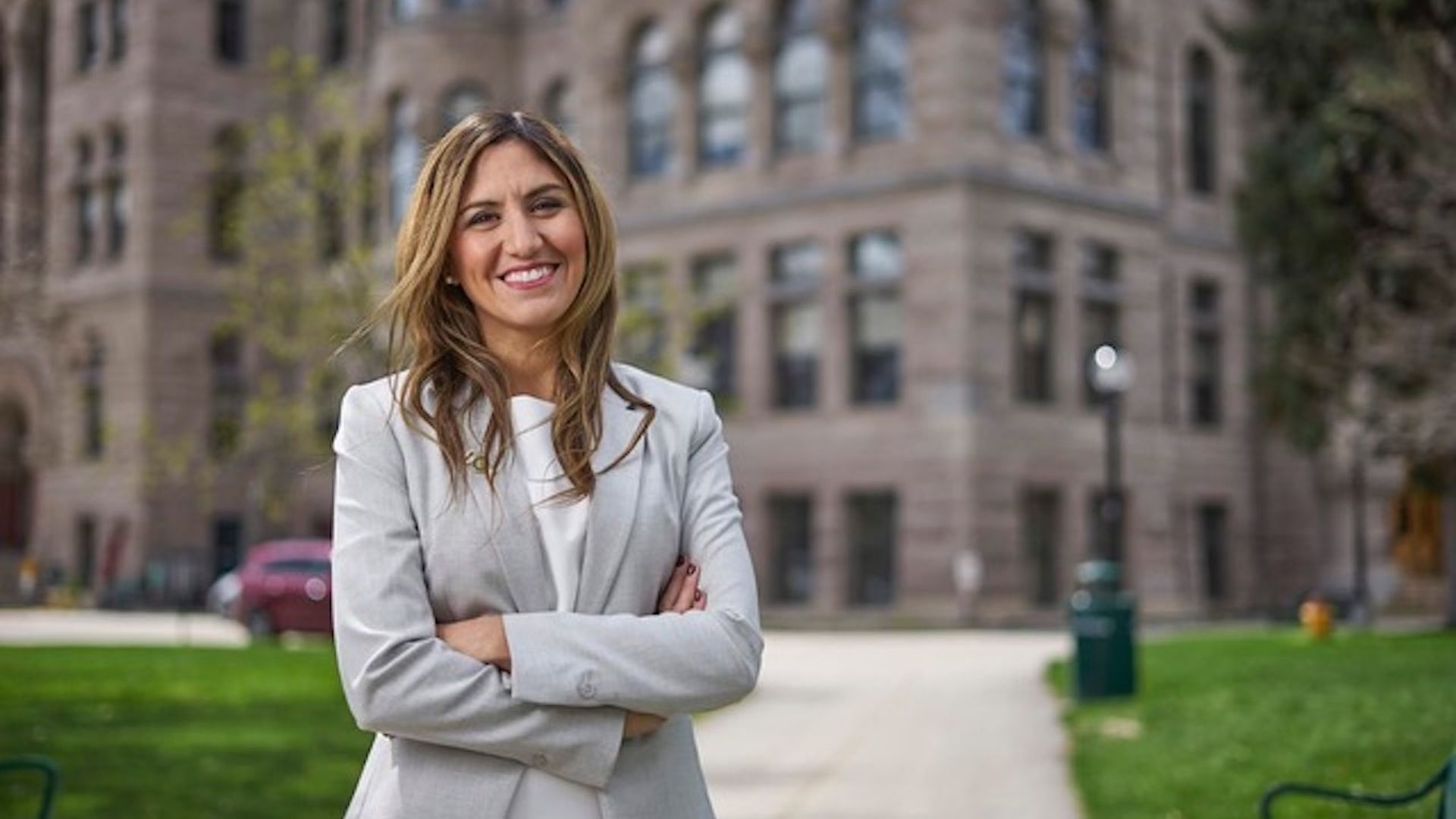 Ana Valdemoros stands in front of the Salt Lake City building