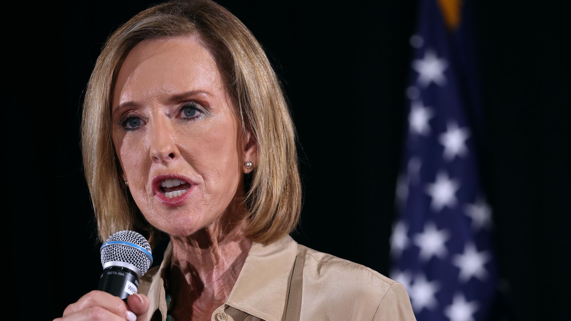 Karrin Taylor Robson speaks into a microphone.