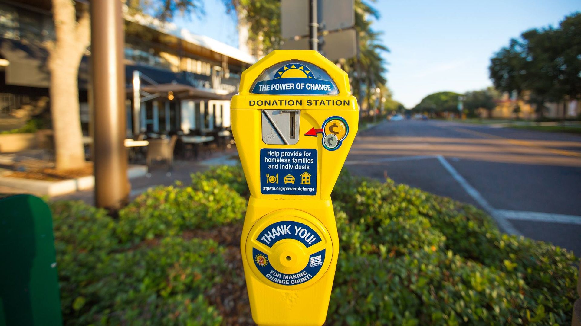 yellow parking meter that says "donation station"