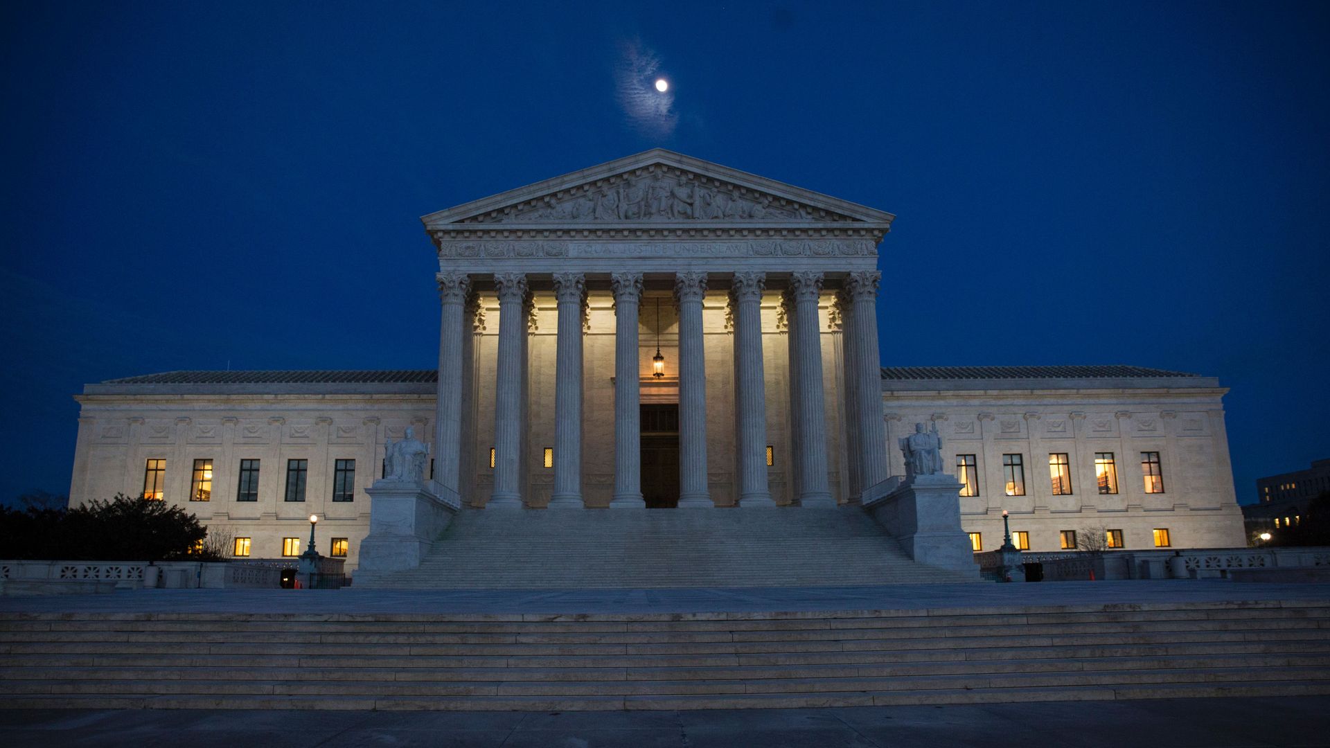 The Supreme Court building lit up at night