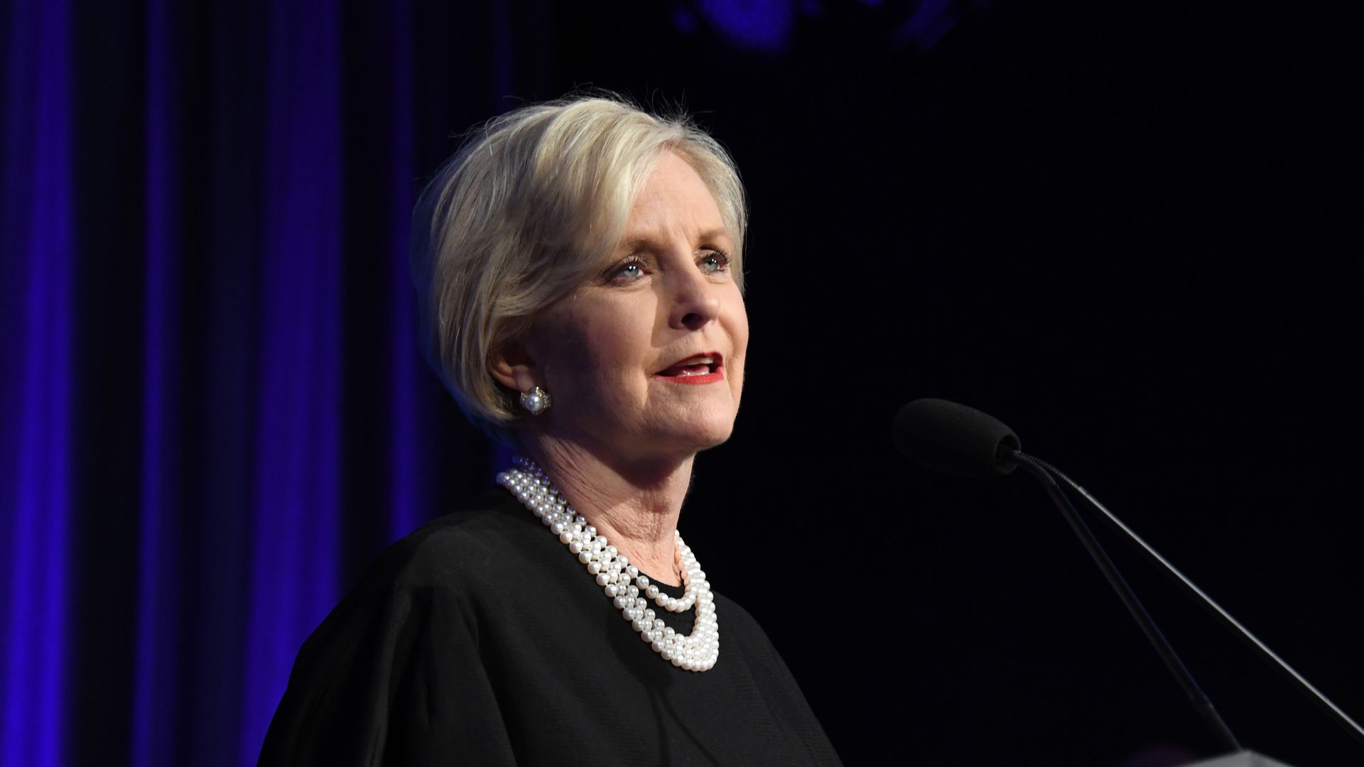 Photo of Cindy McCain in a black outfit speaking from a podium