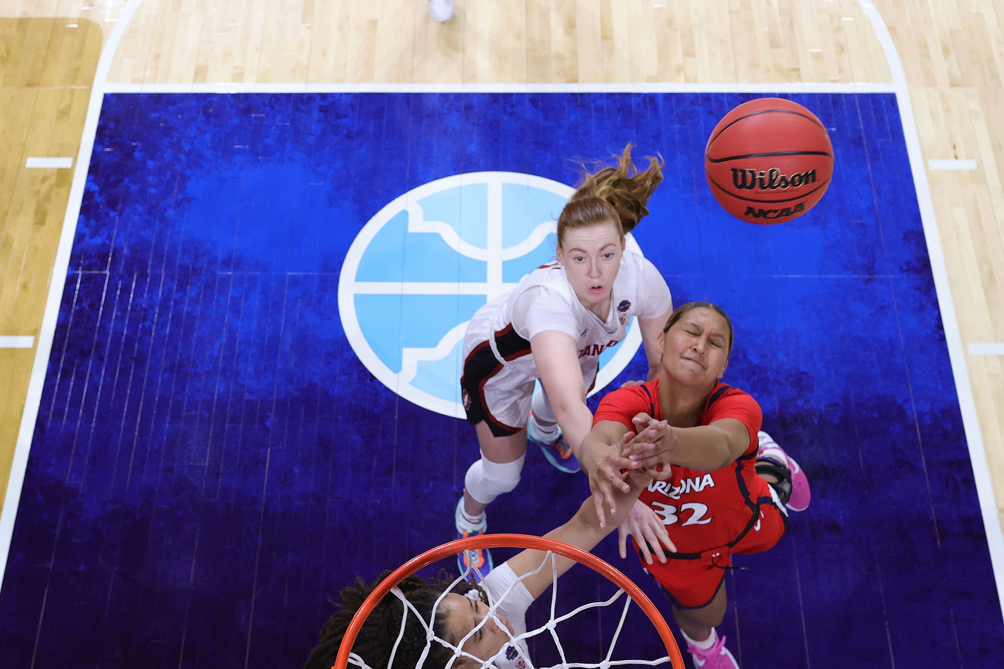 Lauren Ware #32 of the Arizona Wildcats is pressured by Haley Jones #30 #10 of the Stanford Cardinal in the National Championship game