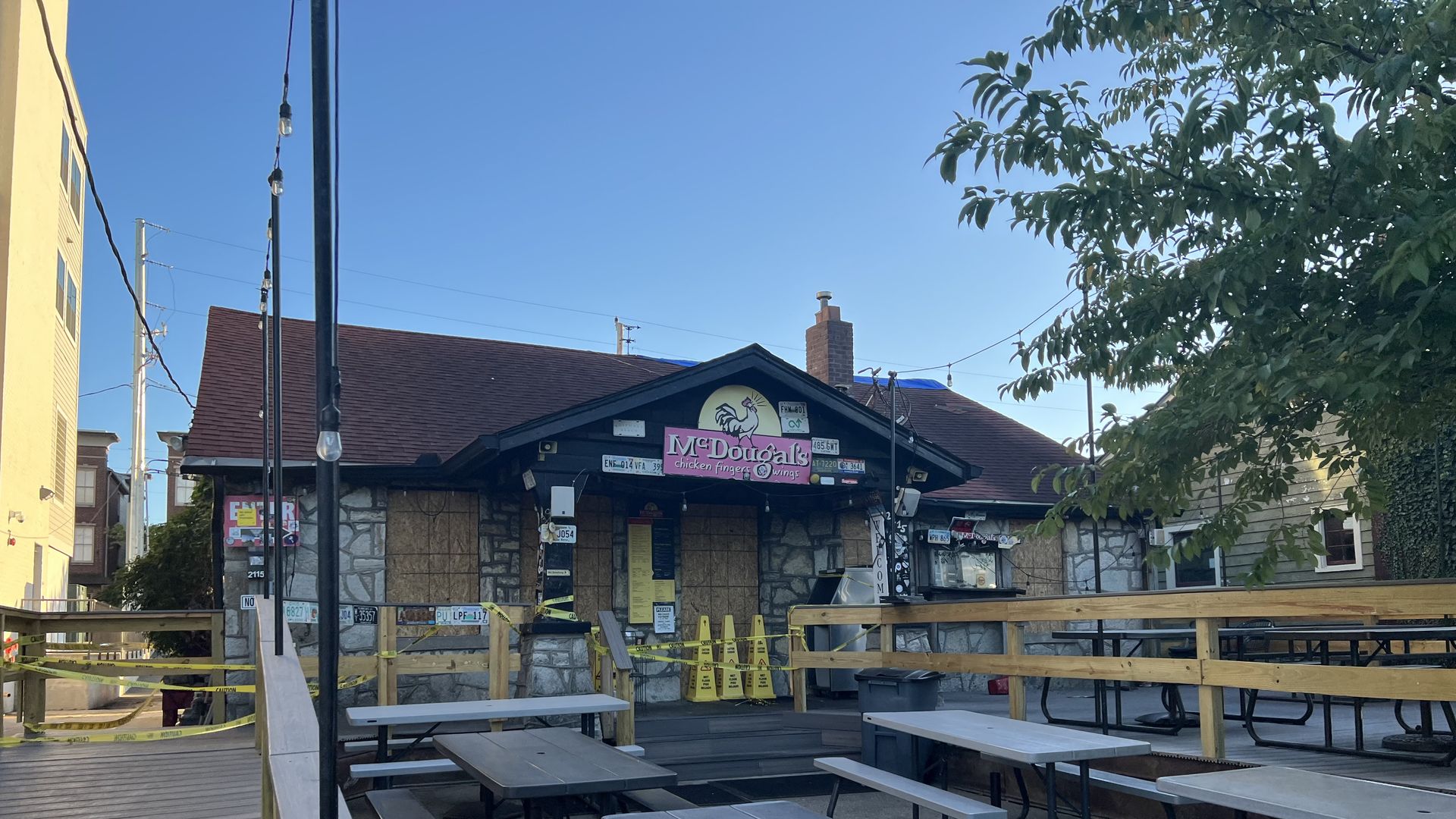 Exterior of McDougal's showing fire damage including boarded up windows