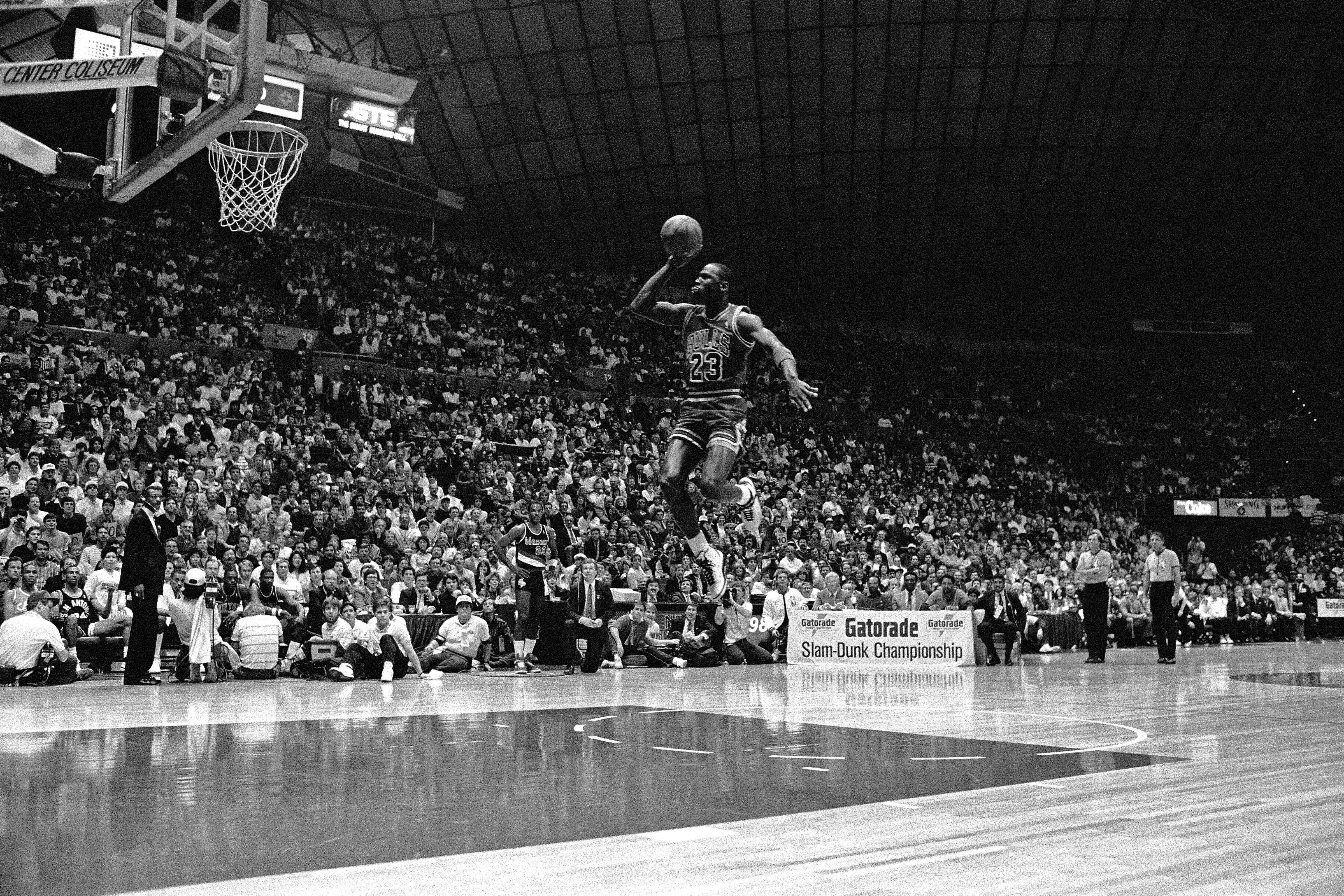 Photo of a basketball player jumping towards hoop