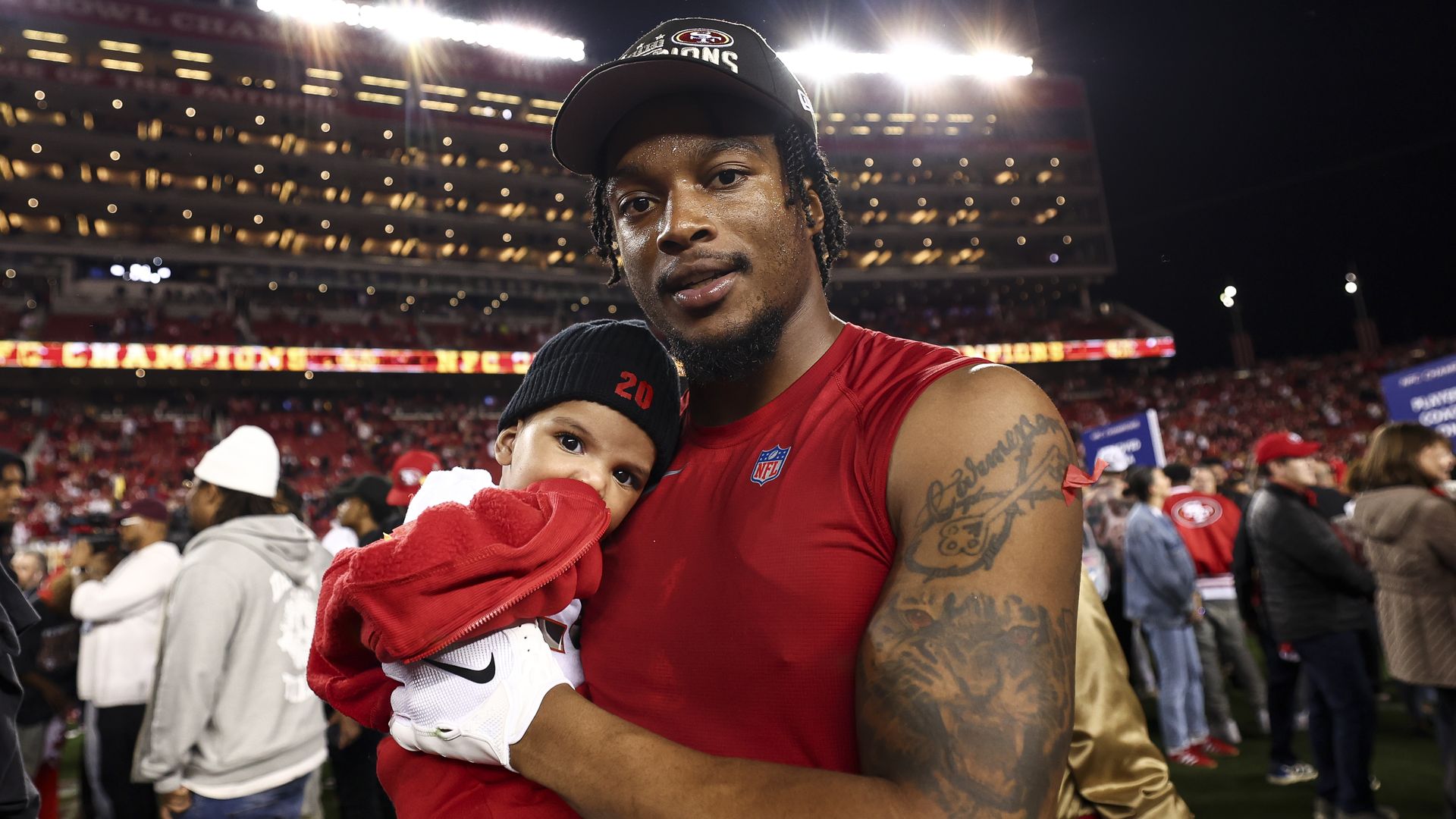 49ers cornerback Ambry Thomas poses with his son after the NFC championship win over Detroit. 