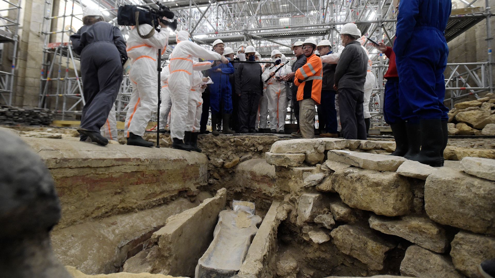 France's Culture Minister Roselyne Bachelot (C, left) visits the Notre Dame Cathedral archaeological research site after the discovery of a 14th century lead sarcophagus, in Paris, on March 15.