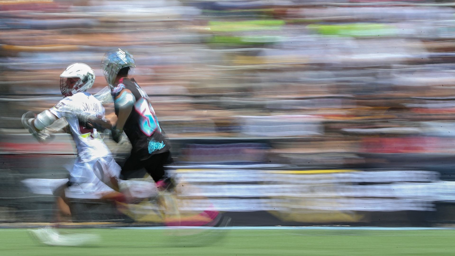 lacrosse players on blurry background
