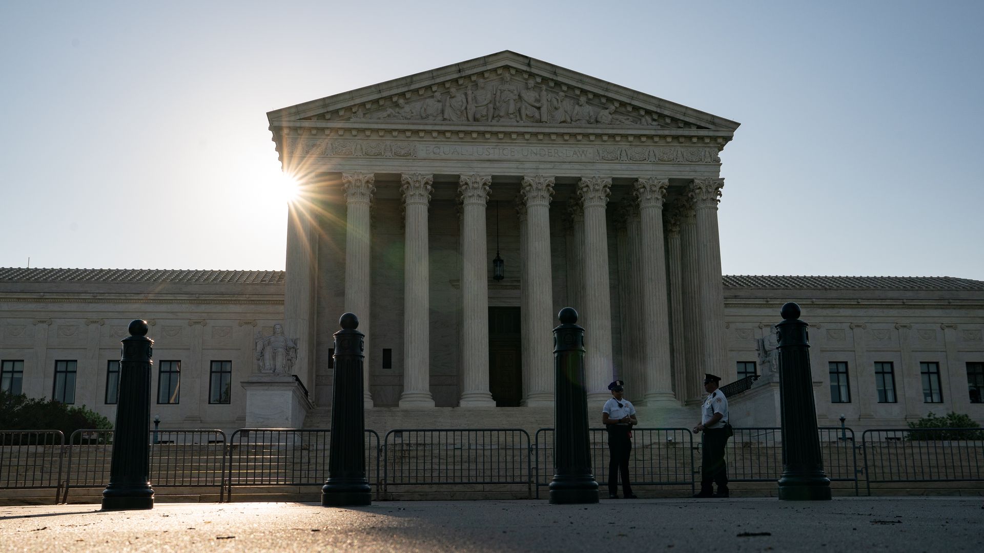 Photo of the sun setting behind the U.S. Supreme Court building